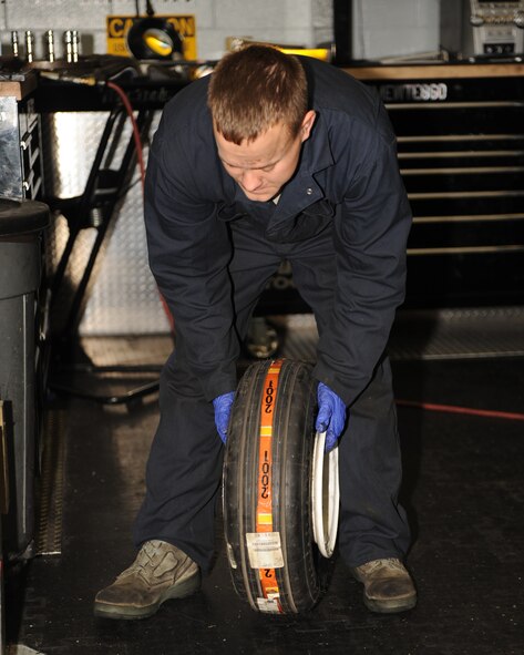 Staff Sgt. Paul Tabor, 4th Equipment Maintenance Squadron inspection team member, checks the air pressure of a newly rebuilt tire on Seymour Johnson Air Force Base, N.C., Nov. 5, 2009. Crew chiefs determine the serviceability of tires. Unserviceable tires are sent to the wheel and tire shop for rebuilding. (U.S. Air Force photo/Senior Airman Ciara Wymbs) 