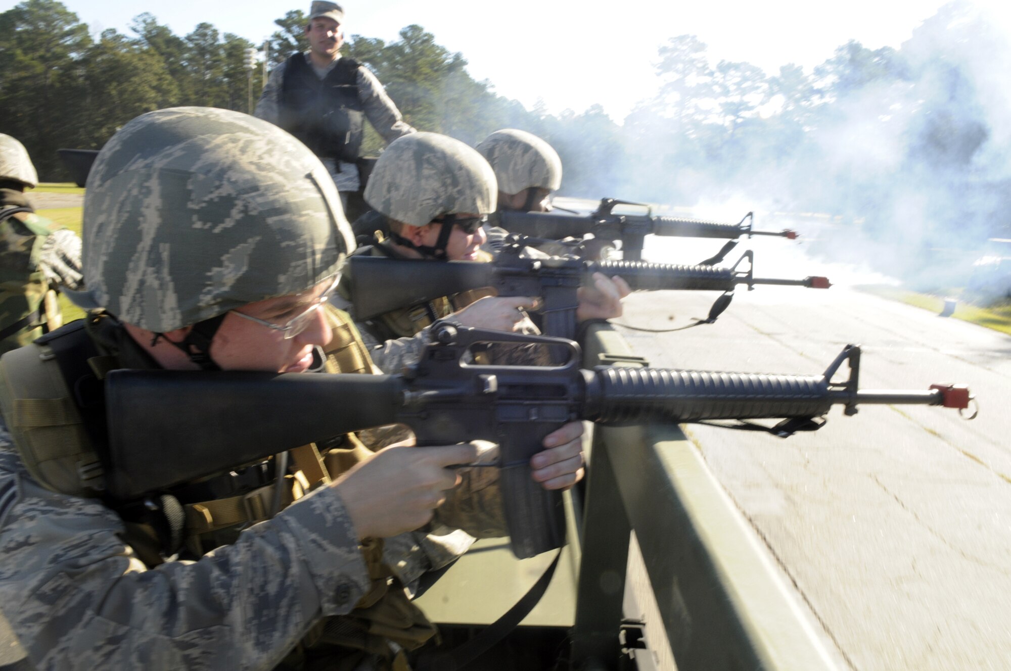 Airmen taking part in 5th Combat Communications  convoy training fire their weapons at opposition from the back of the truck. U. S. Air Force photo by Sue Sapp