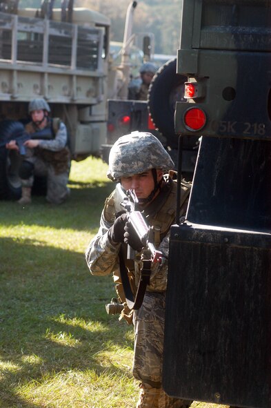 Airmen take part in 5th Combat Communications  take a defensive stance within an enclosed circle of trucks during convoy training Oct. 29. U. S. Air Force photo by Sue Sapp