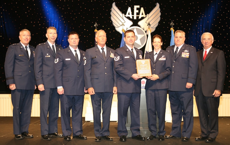 A Maryland Air National Guard C-130 crew is presented the Earl T. Ricks Award for outstanding airmanship by Maj. Gen. William H. Etter, Director of Strategic Plans and Policy for the National Guard Bureau (far left), and Mr. Joseph E. Sutter, Air Force Association Chairman Of The Board (far right). From left to right, they are Lt. Col. Thomas Hans, Tech. Sgt. Billy Shiflett, and Senior Master Sgt. Thomas Kelly of the 135th Airlift Squadron, and Staff Sgt. Brian Miliefsky, a member of the California Air National Guard. (Released)
