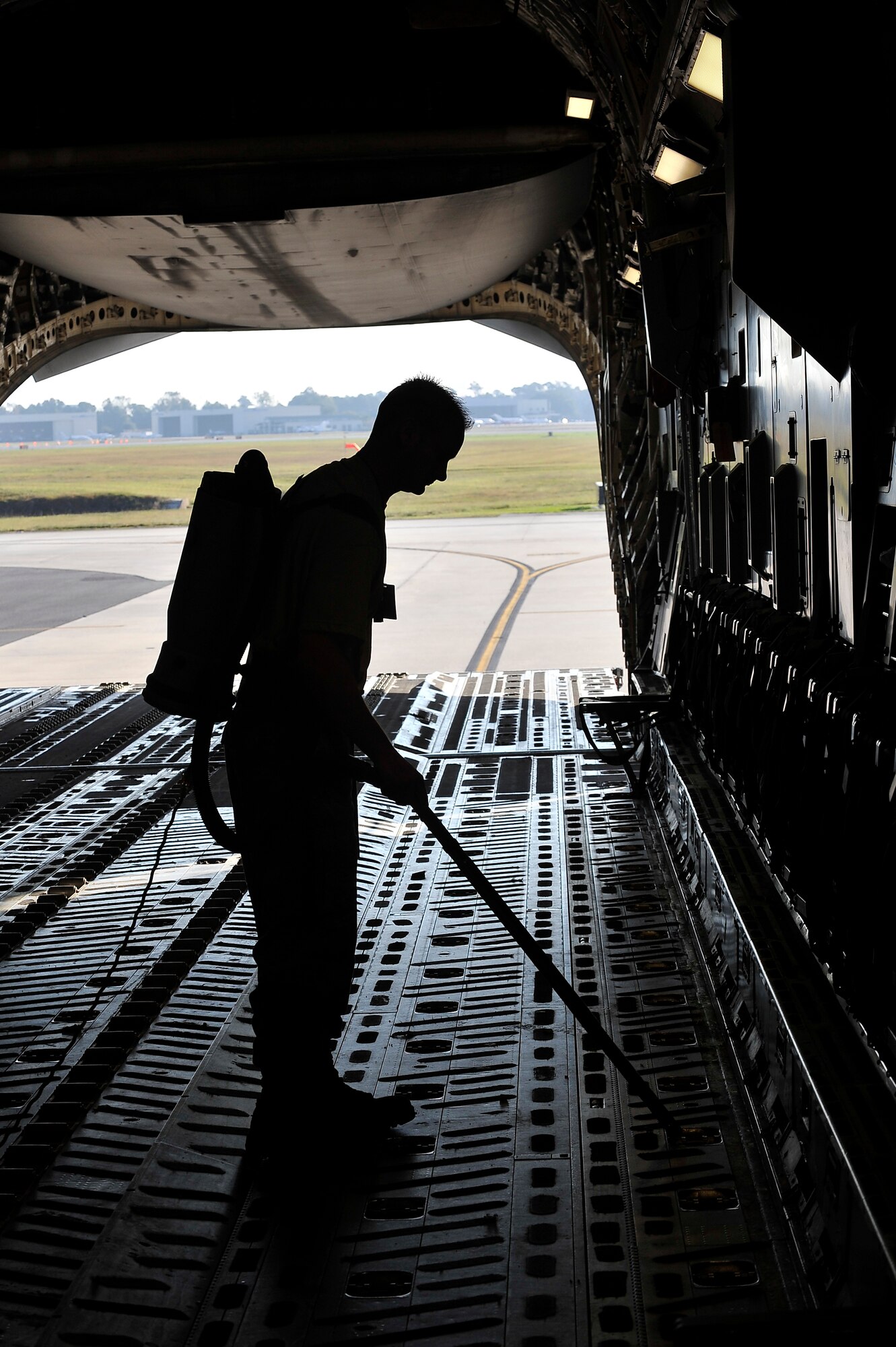 Staff Sgt. Jeffery Sausman  performs foreign object damage cleaning and inspection by vacuuming loose debris from the floor of a C-17 here Nov. 4. Foreign object damage caused by debris is prevented through regular aircraft inspections. Sergeant Sausman is a crew chief with the 315th Aircraft Maintenance Squadron. (U.S. Air Force photo/James Bowman)
 


