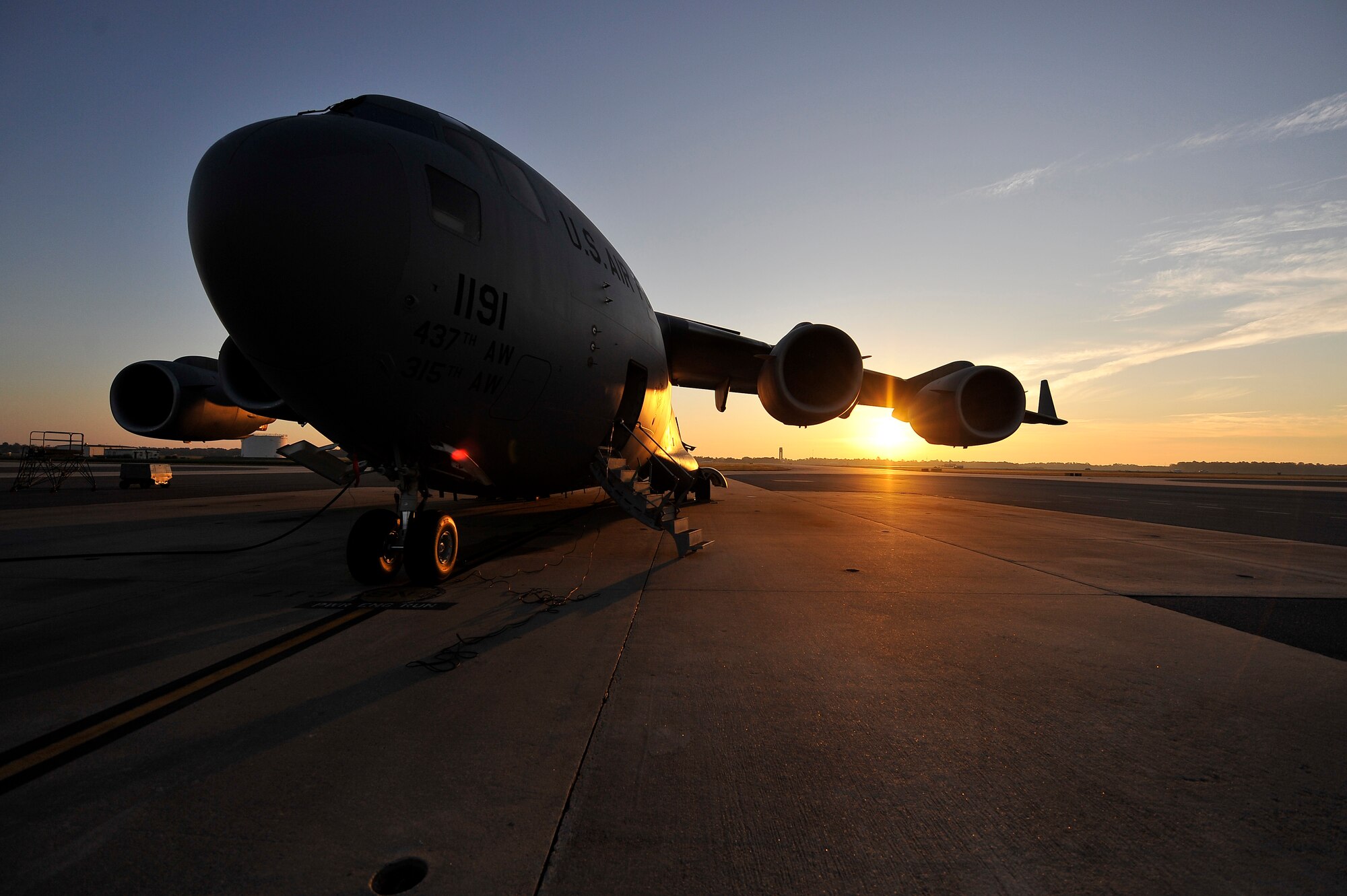A C-17 aircraft assigned to Charleston AFB is parked on the flightline here during sunrise Nov. 4 prior to being flown on a 437th Airlift Wing training mission. The mission of the 437 AW is to command assigned aircraft and supporting units; provide for the airlift of personnel, military equipment and cargo; and to participate in operations involving the airland or airdrop of personnel, equipment and supplies. (U.S. Air Force photo/James Bowman)