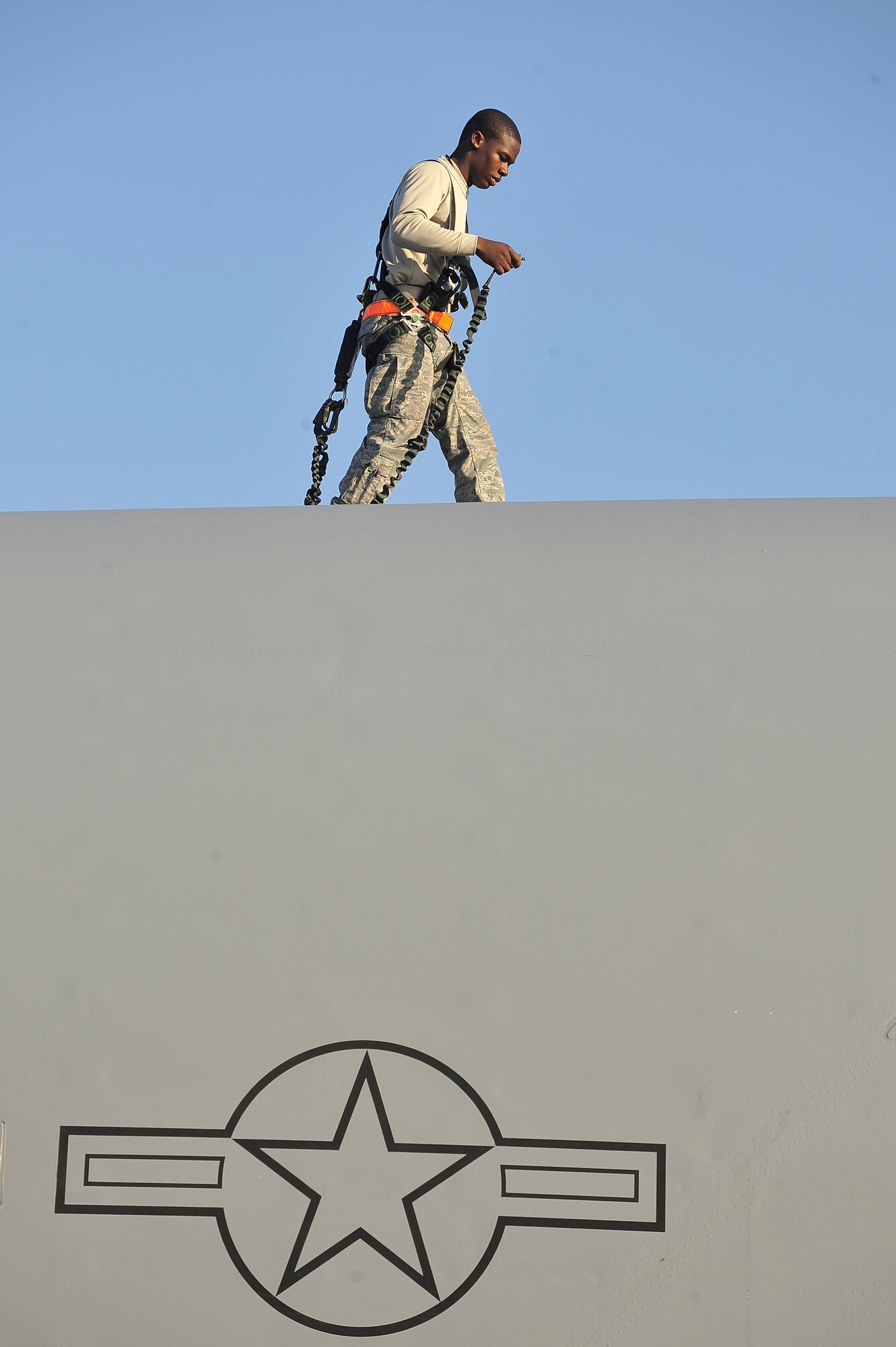 Airman 1st Class Alexander McCall performs an inspection looking for discrepancies on top of a C-17 here Nov. 4. In addition to scheduled and non-scheduled maintenance, inspections are a requirement for all C-17 aircraft to ensure operational integrity during flight. Airman McCall is a crew chief with the 315th Aircraft Maintenance Squadron. (U.S. Air Force photo/James Bowman)
