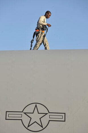 Airman 1st Class Alexander McCall performs an inspection looking for discrepancies on top of a C-17 here Nov. 4. In addition to scheduled and non-scheduled maintenance, inspections are a requirement for all C-17 aircraft to ensure operational integrity during flight. Airman McCall is a crew chief with the 315th Aircraft Maintenance Squadron. (U.S. Air Force photo/James Bowman)