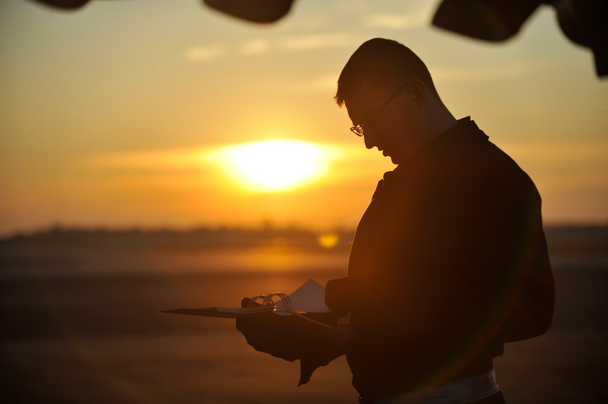 Senior Airman Nick Yashirin reads a technical manual during a C-17 preflight inspection here Nov. 4. In addition to scheduled and non-scheduled maintenance, inspections are a requirement for all C-17 aircraft to ensure operational integrity during flight. Airman Yashirin is a crew chief with the 437th Aircraft Maintenance Squadron. (U.S. Air Force photo/James Bowman)