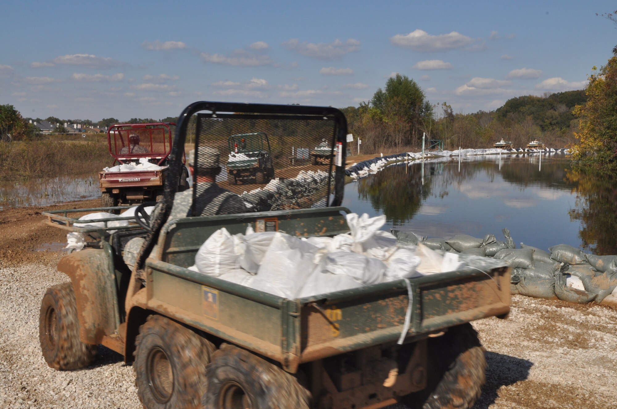 Soldiers from the 527th Engineers of the Louisiana National Guard move hundreds of sand bags from a staging area to strategic locations on a levee in a northern Bossier Parish neighborhood November 4, 2009. Hundreds of Airmen from Barksdale Air Force Base La., joined together with Soldiers from the 527th Engineers of the Louisiana National Guard and other volunteers on Oct. 31 to sand bag a levee containing the Red Chute Bayou.  Sand bags were still being placed during the evening of November4. (U.S. Air Force photo/Tech. Sgt. Jeff Walston)