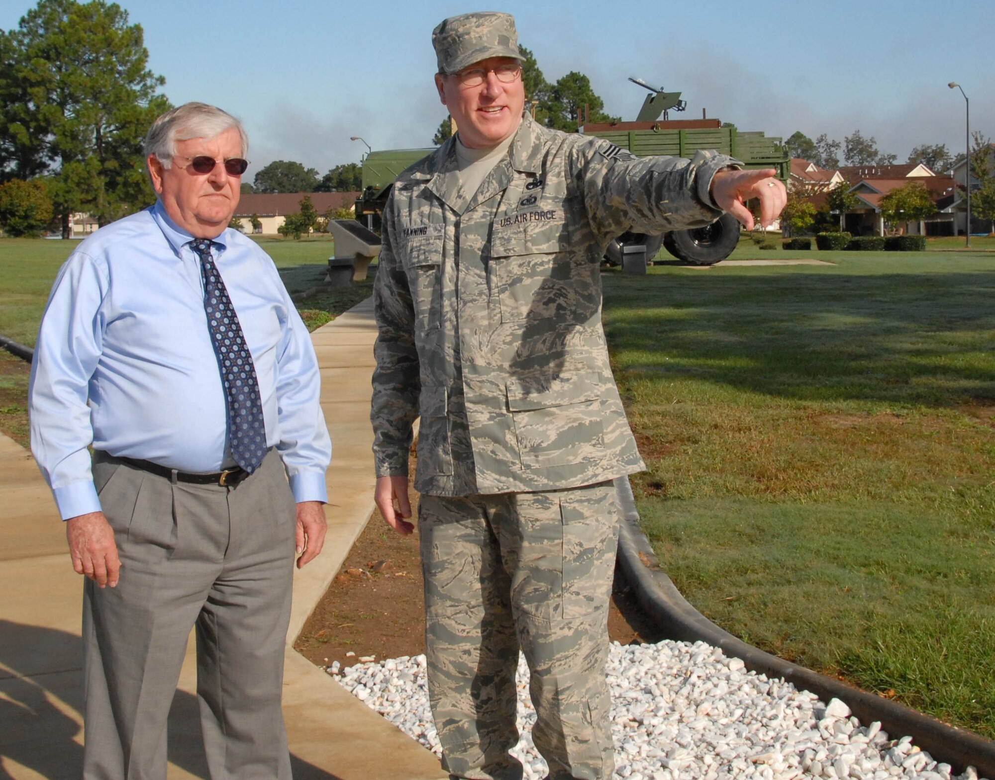 Enlisted Heritage Research Institute director, Chief Master Sgt. Rick Fanning (right) explains to Walter Dzialo, president of the Montgomery Chapter of the National Defense Transportation Association, what the $500 NDTA donation to EHRI will be used for. Chief Fanning said the money, raised during the NDTA's annual golf tournament, will go to help complete the walkway that leads to the Enlisted Heritage Hall museum's two outdoor exhibits. (U.S. Air Force photo/Roger Curry)