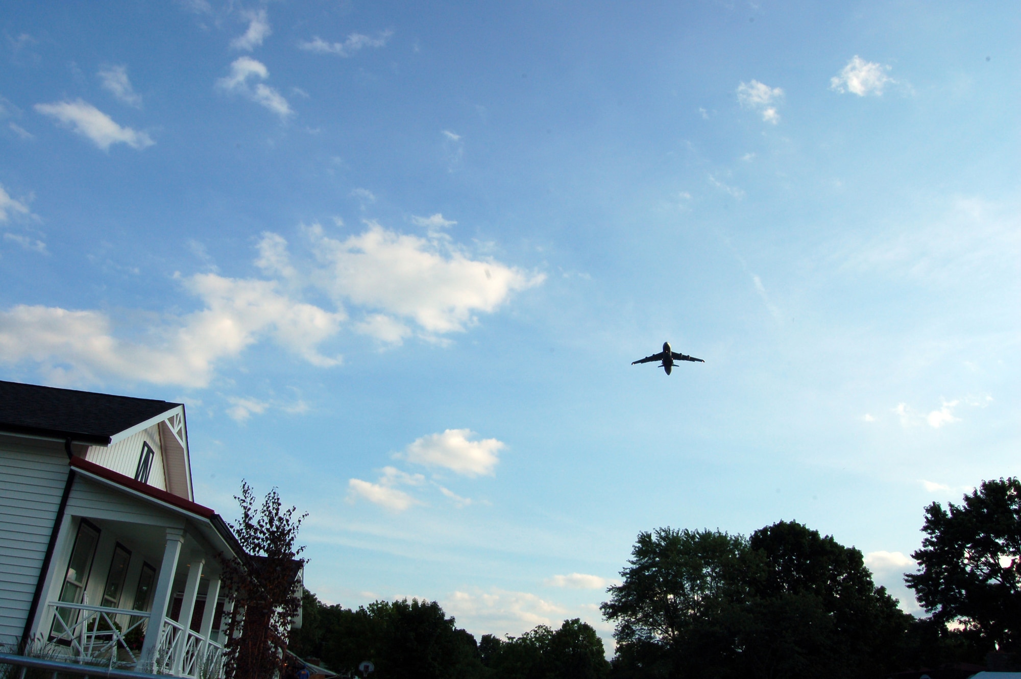 WRIGHT-PATTERSON AIR FORCE BASE, Ohio - A 445th Airlift Wing C-5 Galaxy performs a flyover for Mr. James Terpenning and family as their house is unveiled as part of the television show 'Extreme Makeover: Home Edition' on Aug. 6, 2009. The episode featuring the Terpenning family will air Nov. 8 on ABC at 8 p.m./7 p.m. Central time. (U.S. Air Force photo/Maj. Jose Cardenas)