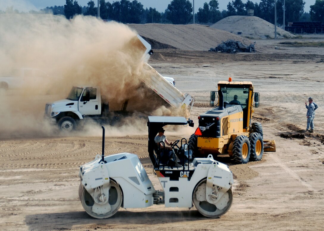 JOINT BASE BALAD, Iraq -- Airmen of the 732nd Expeditionary Civil Engineer Squadron prepare the grounds for a new container repair yard Nov. 2, 2009. By using containers repaired here instead of purchasing new ones, the projected savings total more than $100 million as military assets withdraw from Iraq. (U.S. Air Force photo/Senior Airman Christopher Hubenthal)
