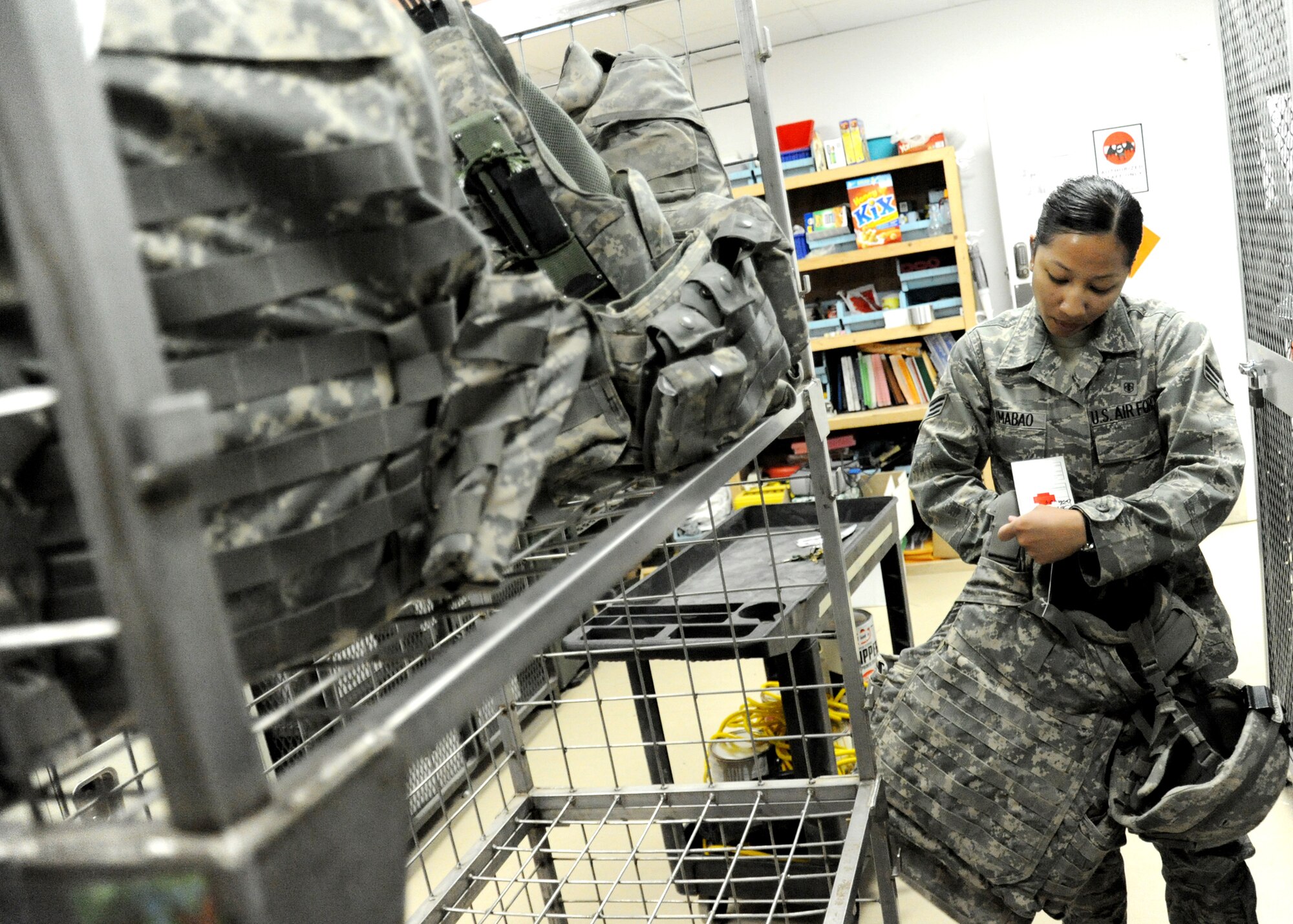 JOINT BASE BALAD, Iraq -- Senior Airman Faith Lumabao, 332nd Expeditionary Medical Support Squadron patient valuables and bed status technician, tags a patient’s body armor in a secured vault at the Air Force Theater Hospital Nov. 2, 2009. Airman Lumabao is responsible for securing patient valuables, weapons, ammunition and armor upon their arrival. (U.S. Air Force photo/Senior Airman Christopher Hubenthal)