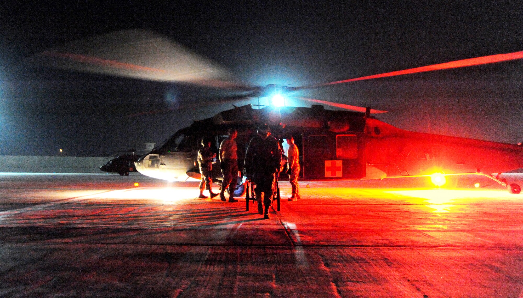 JOINT BASE BALAD, Iraq – Hospital volunteers transport a patient toward the emergency department on a litter after unloading an HH-60G Pave Hawk at the Air Force Theater Hospital Nov. 2, 2009. Hospital volunteers spend their free time assisting hospital personnel in a variety of ways, and are available in the event of a mass casualty. (U.S. Air Force photo/Senior Airman Christopher Hubenthal)