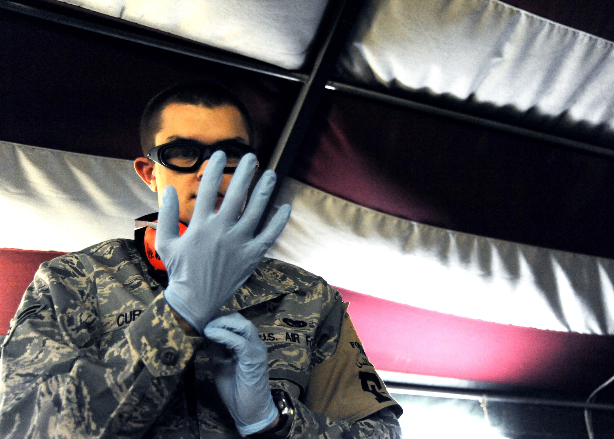 JOINT BASE BALAD, Iraq -- Airman 1st Class Nicholas Curcuru, 332nd Expeditionary Civil Engineer Squadron third country national escort and hospital volunteer, prepares for the arrival of a medical helicopter at the Air Force Theater Hospital Nov. 2, 2009. Hospital volunteers spend their free time assisting hospital personnel in a variety of ways, and are available in the event of a mass casualty. (U.S. Air Force photo/Senior Airman Christopher Hubenthal)