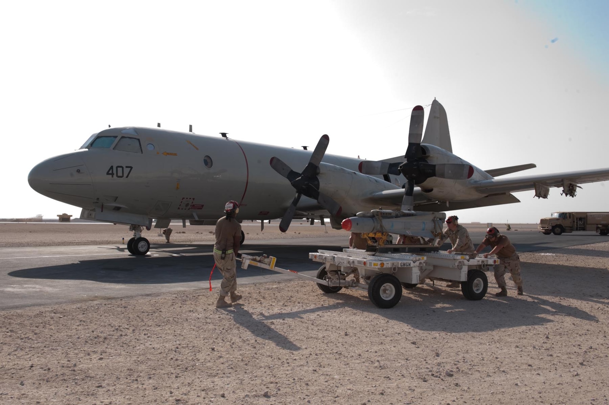 U.S. Navy Aviation Ordnancemen from Patrol Squadron 10 push a weapons trailer after recovering a Captive Air Training Armament 65 maverick missile loaded on a P-3 Orion, Nov. 4, 2009, in Southwest Asia. The VP-10 P-3s, deployed from Jacksonville Naval Station, Fla., are four-engine turboprop anti-submarine and maritime surveillance aircraft capable of carrying CATM-65s in support of operations Iraqi and Enduring Freedom. (U.S. Air Force photo/Staff Sgt. Robert Barney) 
