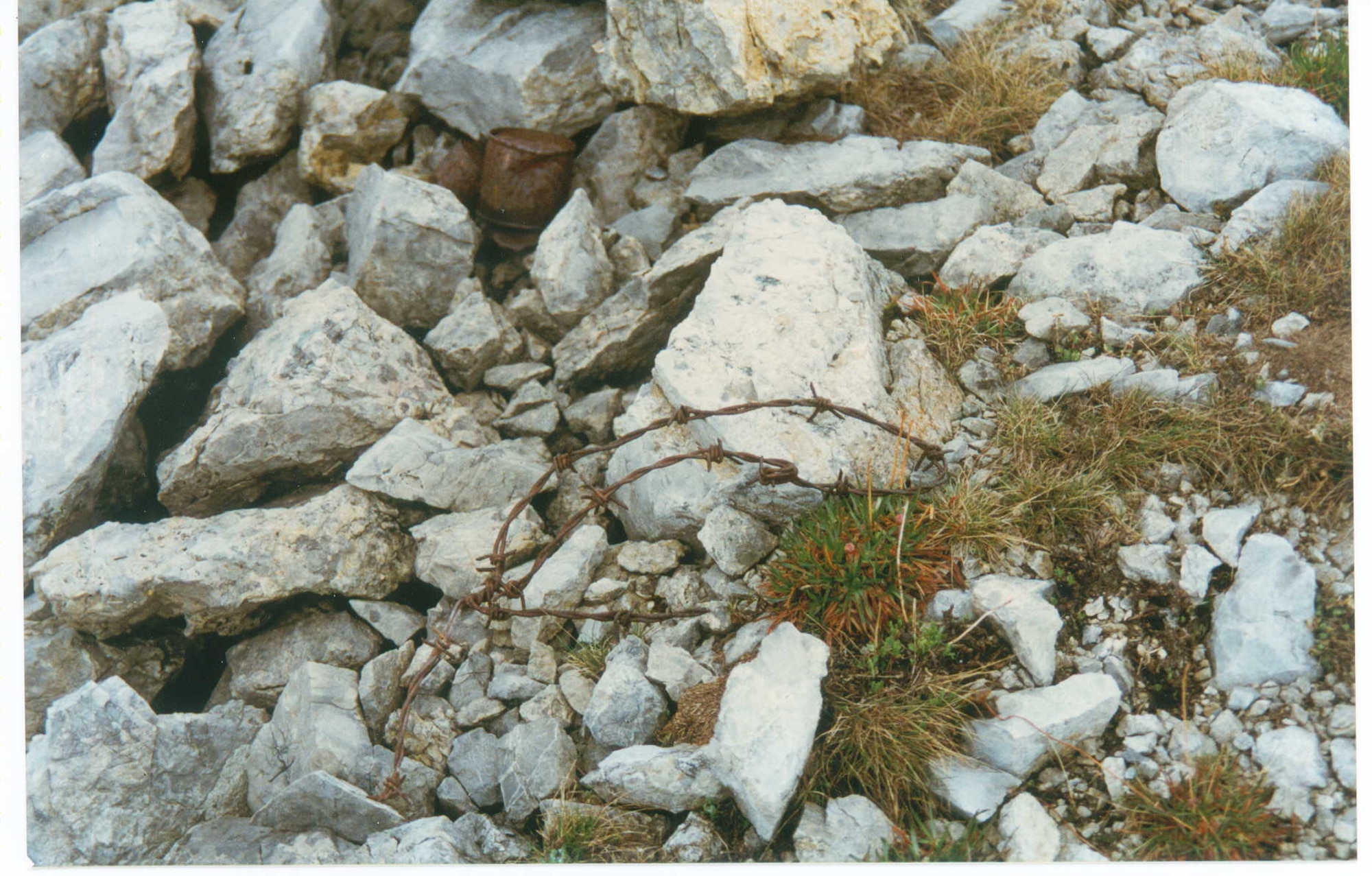 This photograph shows the site on Monte Grappa, Italy,  where the bones of the unknown Austrian soldier from World War I were buried.  Note the food tins, barbed wire, and bits of shrapnel. (Photo courtesy of Bill Harris)