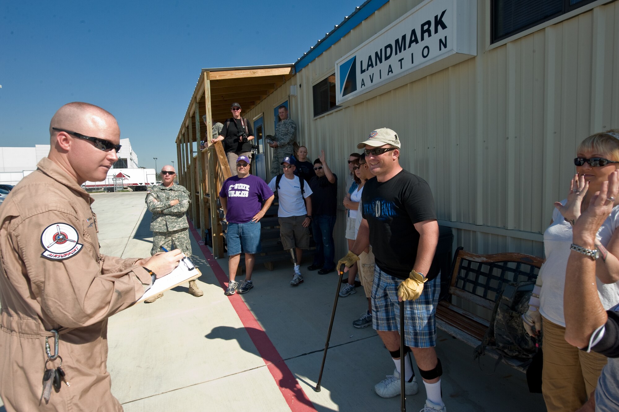 Justin Growden of the Disabled American Veterans Flight Team welcomes wounded warriors and their families Nov. 5, 2009, to the San Antonio International Airport for flights on historic military aircraft and experimental acrobatic planes.  When he asked who wants to fly in a B-25 Mitchell bomber, hands quickly went up.  The wounded warriors are from the Warrior Transition Unit of the San Antonio Military Medical Center at Fort Sam Houston, Texas. Approximately 10 aircrews have come here from across the region to participate in the Randolph Air Force Base "Forging the Future" Air Show on November 7 and 8. (U.S. Air Force photo/Lance Cheung)