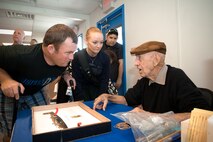 Air Force Staff Sgt. Richard Pollock (left) and Army National Guard Sgt. Kisha Makerney asks (ret.) Lt. Col, Dick Cole a question about the Doolittle raid on Tokyo during WWII. Cole was Col. Jimmy Doolittle's co-pilot for the historic raid.  Disabled American Veterans Flight Team coordinated a flight day for wounded warriors and their family on Nov. 5, 2009. They will be flying in historic military aircraft and experimental acrobatic planes at San Antonio International Airport, Texas. Makerney a Ft. Townsend, OK native and Pollock are currently assigned to the San Antonio Military Medical Center. Col. Cole and aircrews have come here from across the region to participate in the Randolph Air Force Base Forging the Future Air Show on November 7-8. (U.S. Air Force photo/Lance Cheung)