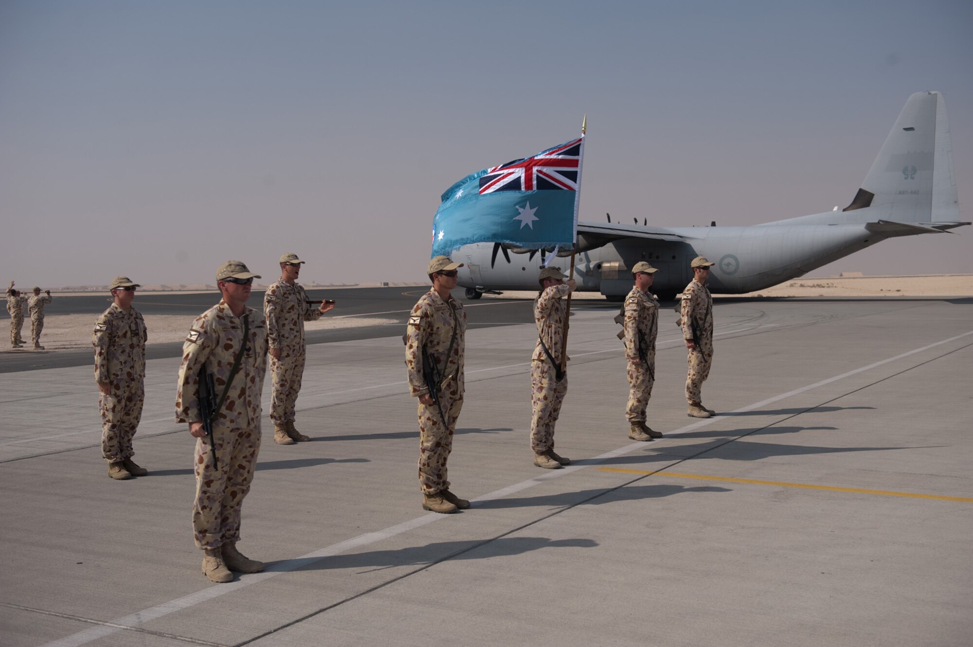 A Royal Australian Air Force honor guard from No. 37 Squadron renders honors to the last C-130J to take off on a mission from here, Nov. 5, 2009, in Southwest Asia. The squadron is moving its operations to another location in Southwest Asia after six years of operating out of this undisclosed location in SWA. Members are deployed from RAAF Base Richmond, New South Wales, Australia in support of Operation Slipper, Australian's military contribution to international campaigns against terrorism. (U.S. Air Force photo/Staff Sgt. Robert Barney)