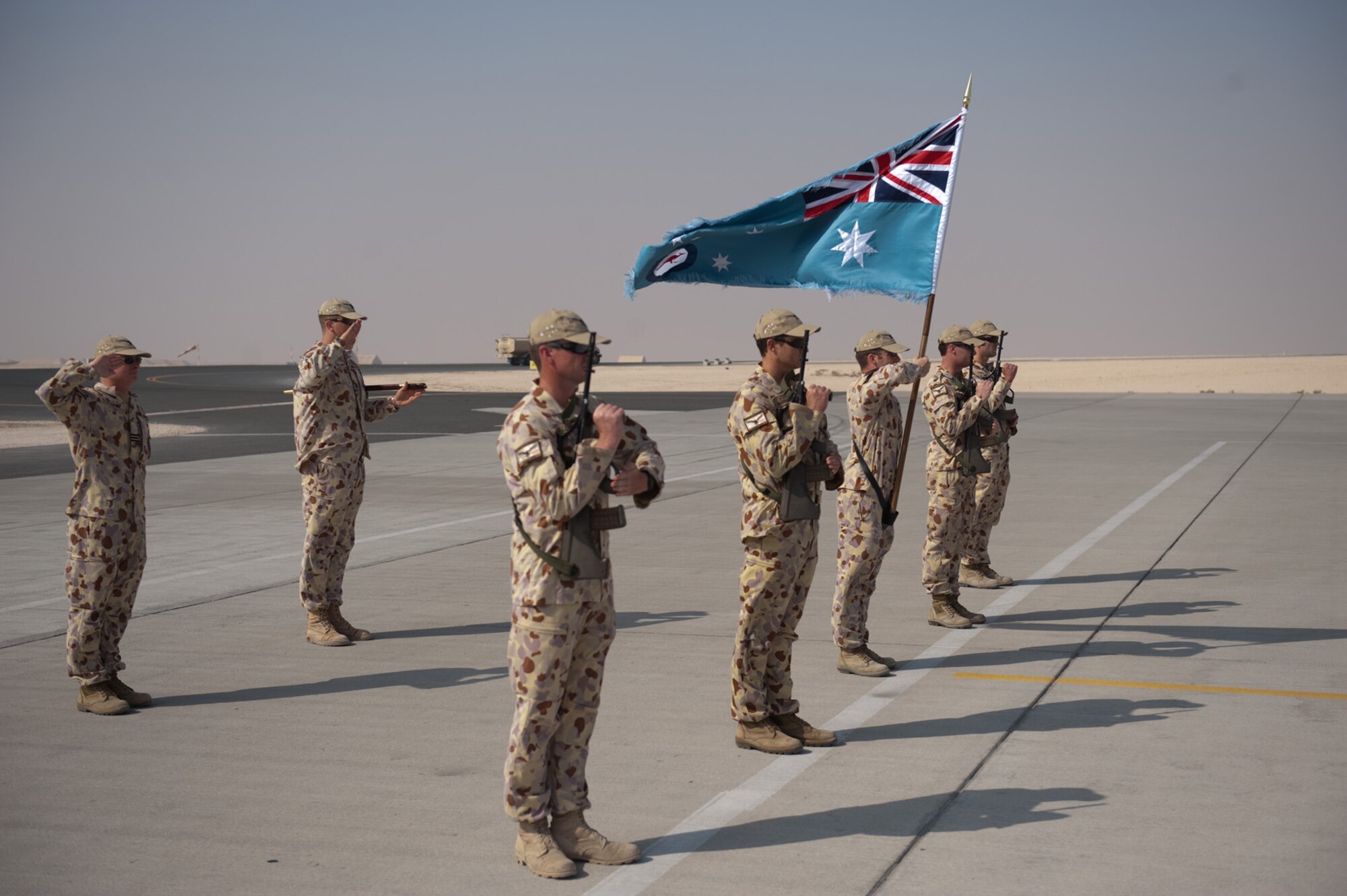 A Royal Australian Air Force honor guard from No. 37 Squadron renders honors to the last C-130J to take off on a mission from here, Nov. 5, 2009, in Southwest Asia. The squadron is moving its operations to another location in Southwest Asia after six years of operating out of this undisclosed location in SWA. Members are deployed from RAAF Base Richmond, New South Wales, Australia in support of Operation Slipper, Australian's military contribution to international campaigns against terrorism. (U.S. Air Force photo/Staff Sgt. Robert Barney)