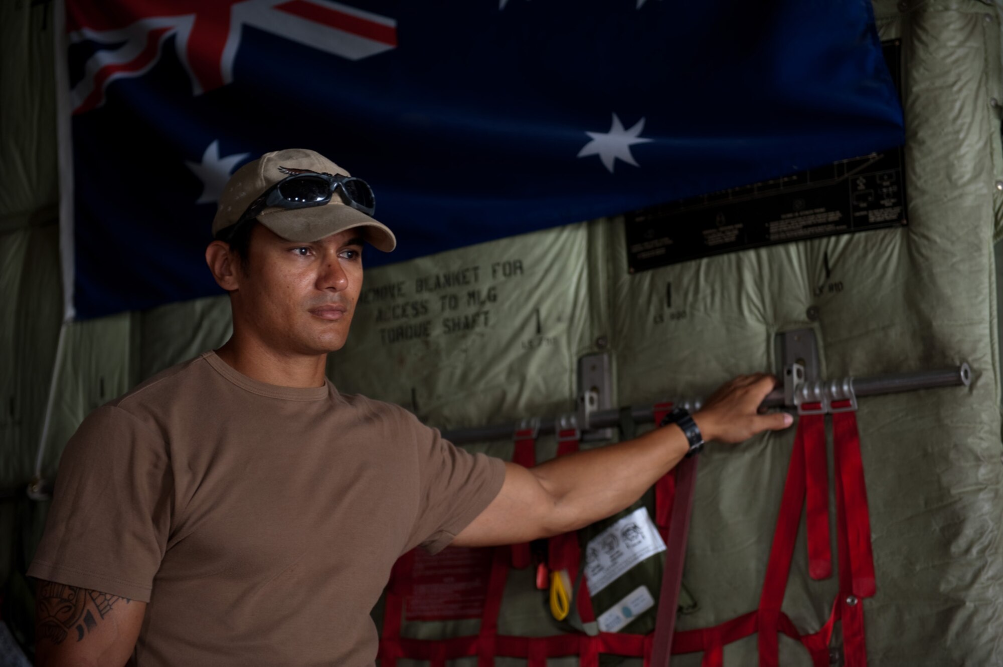 Royal Australian Air Force Corp. Michael Godfrey, No. 37 Squadron air load team member, helps load a C-130J, Nov. 5, 2009, in Southwest Asia. The No. 37 Squadron is moving its operations to another location in Southwest Asia after six years of operating out of this undisclosed location in SWA. Corporal Godfrey is deployed from RAAF Base Richmond, New South Wales, Australia in support of Operation Slipper, Australian's military contribution to international campaigns against terrorism. (U.S. Air Force photo/Staff Sgt. Robert Barney) 