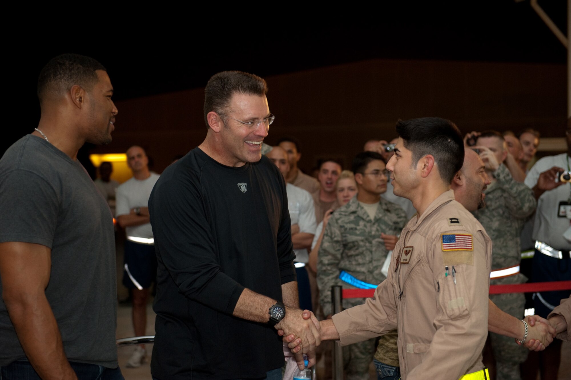 Howie Long, NFL on FOX analyst and former defensive end for the Oakland Raiders, visits with deployed servicemembers in Southwest Asia, Nov. 4, 2009. Mr. Long is touring the U.S. Central Command's area of responsibility as part of an Armed Forces Entertainment-sponsored tour. (U.S. Air Force Photo/Staff Sgt. Robert Barney)