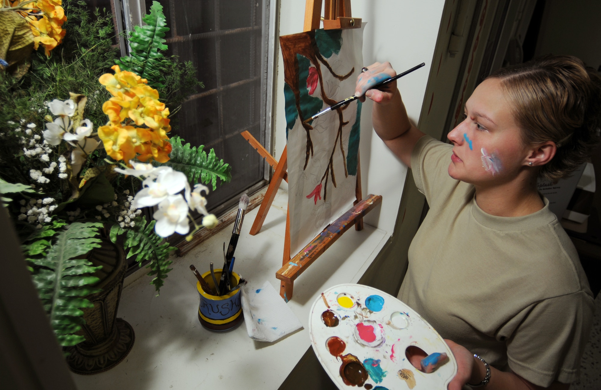 Senior Airman Ashley Wood, 39th Air base Wing public affairs, works on a painting at the Arts and Crafts Center Tuesday, Nov. 3, 2009 at Incirlik Air Base, Turkey. Along with several shops for Team Incirlik members to practice creative skills, the ACC offers a variety of art material and room to work for people to paint, draw or just find some inspiration. (U.S. Air Force photo/Senior Airman Sara Csurilla)