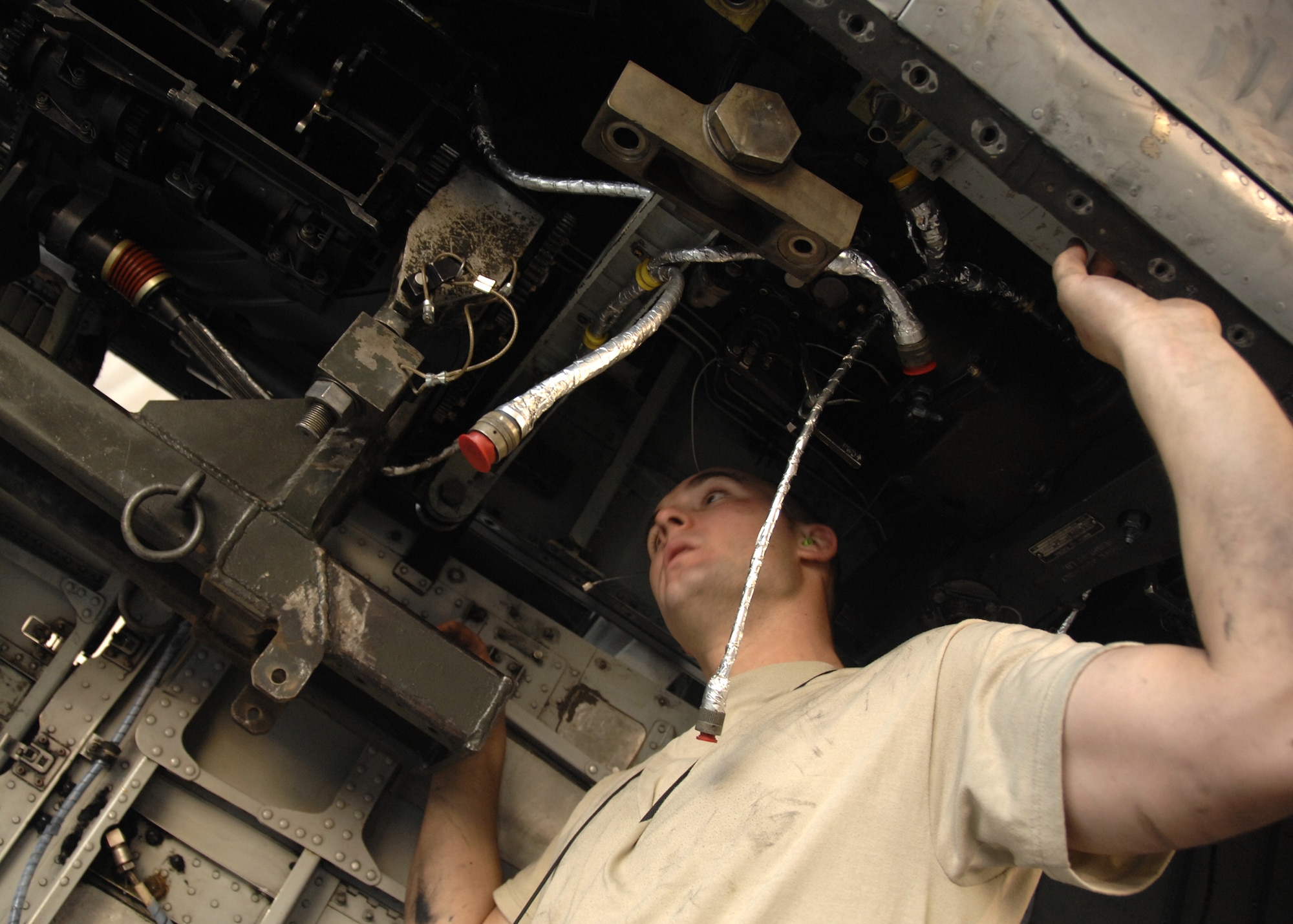 KANDAHAR AIRFIELD, Afghanistan - Staff Sgt. Ryan Van den Brand visually ensures there is enough clearance available as a GAU-8 30 mm weapon system is lifted into place for installation here, Nov. 4, 2009. At 4,000 feet 80 percent of rounds fired hit within a 20-foot radius. Sergeant Van den Brand is an armament troop for the 451st Expeditionary Aircraft maintenance Squadron from Davis-Monthan Air Force Base, Ariz. (U.S. Air Force photo/Senior Airman Timothy Taylor)