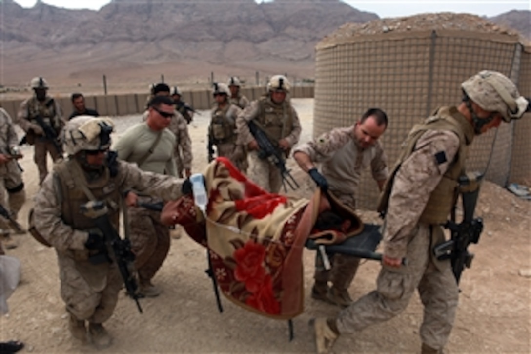 U.S. Marines and sailors with India Company, 3rd Battalion, 4th Marine Regiment transport an injured Afghan boy for medical treatment at Forward Operating Base Golestan in the Helmand province of Afghanistan on Nov. 1, 2009.  The boy fell from an unknown height and was in critical condition.  