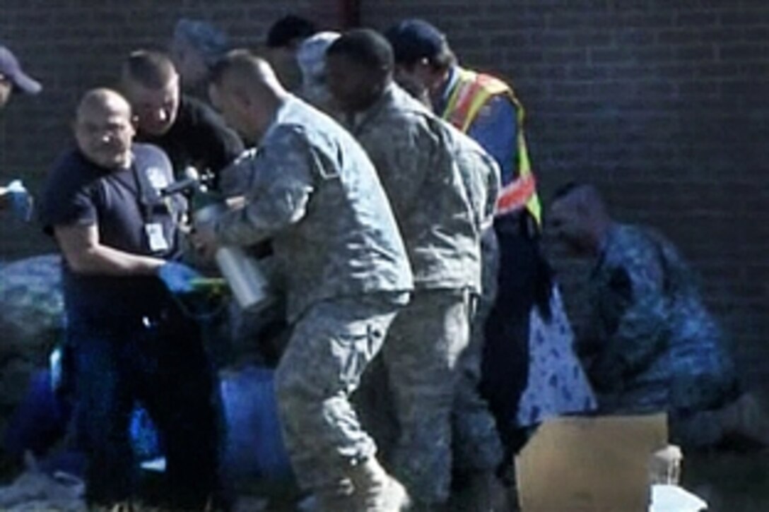 First responders carry a victim to an ambulance during the deadly shooting on Fort Hood, Texas, Nov. 5, 2009. Thirteen people were killed and 30 were injured in the incident.