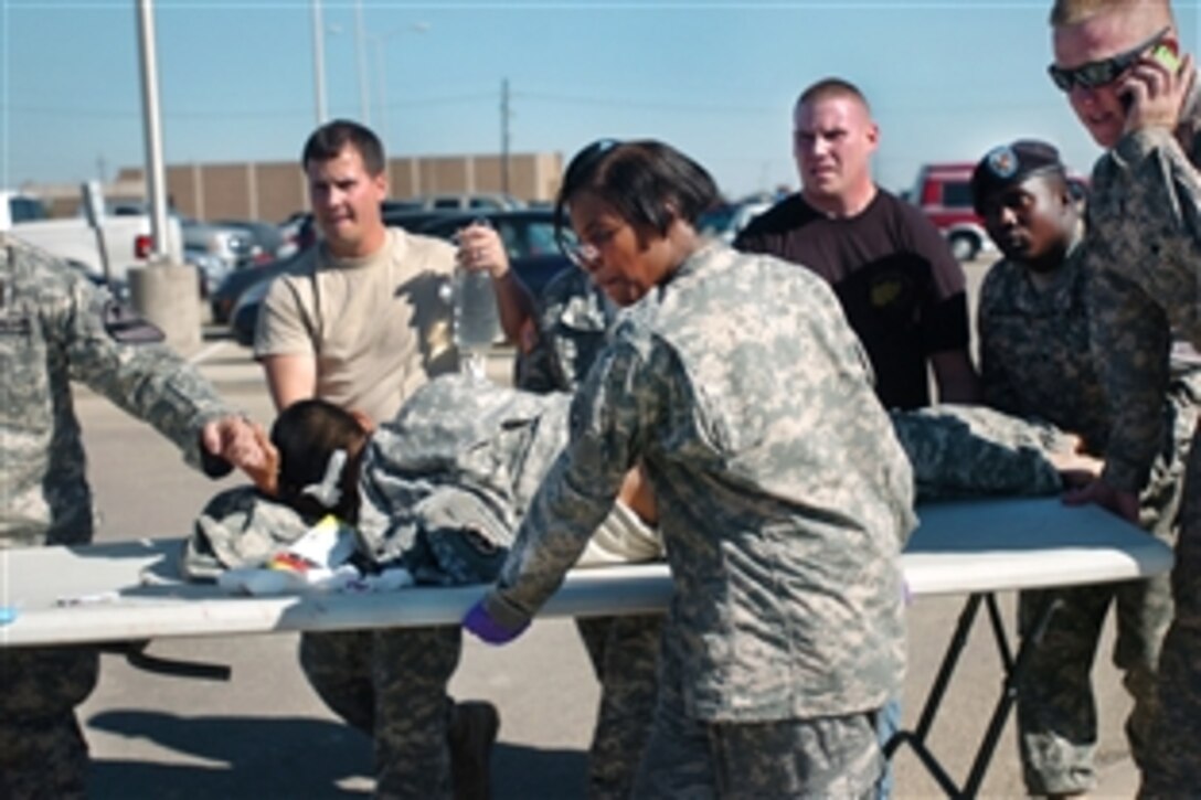 First responders use a table as a stretcher to transport a wounded soldier to a waiting ambulance at Fort Hood, Texas, Nov. 5, 2009.