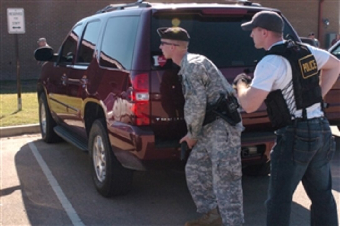 Post police take cover when a gunman fires shots at the Soldier Readiness Processing Center on Fort Hood, Texas, Nov. 5, 2009.