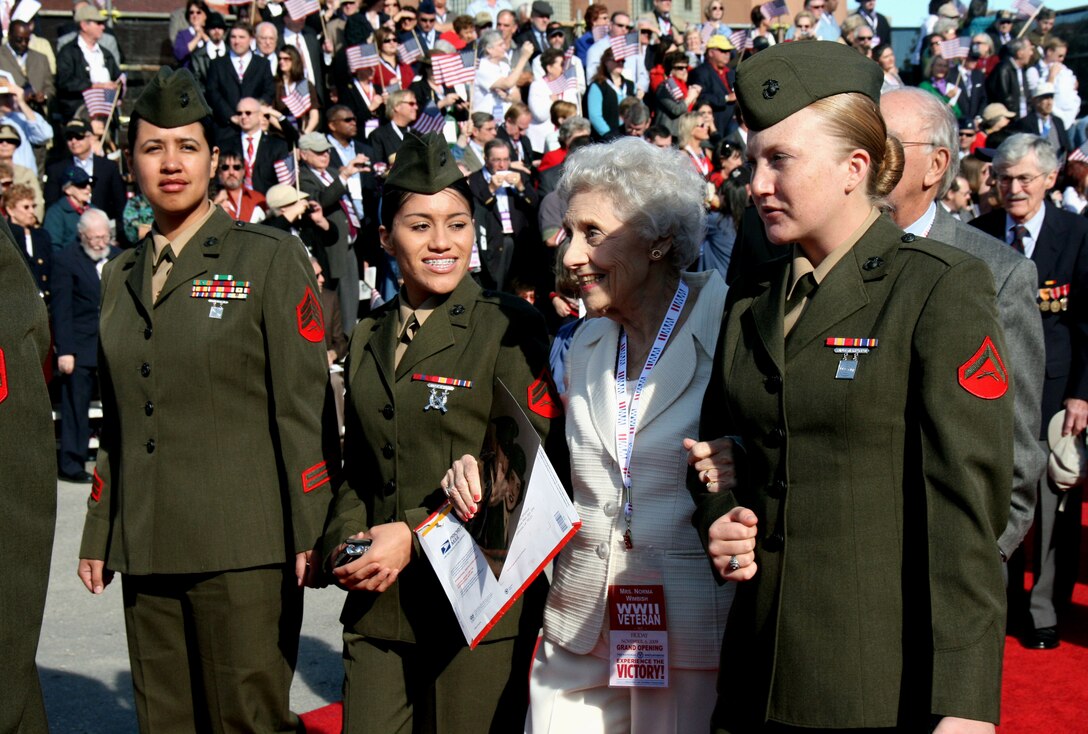 Marines from Headquarters, Marine Forces Reserve, escort Cpl. Nora Wimbish during a ceremony Nov. 6, 2009 at the National World War II Museum.  Wimbish served as a teletype operator in the Marine Corps from 1943-1945.  On her right is Lance Cpl. Nicole Ostrander.  Also pictured are Cpl. Corina Quesada and Sgt. Sandra Batista (far left).
