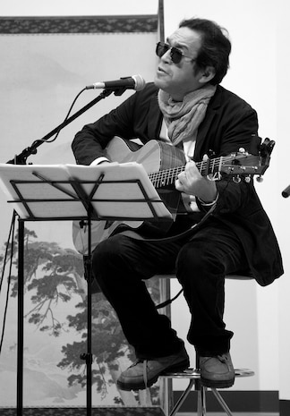 Folk singer Jiro Mouri plays a song during the third annual Japanese and American Friendship Concert here Nov. 6. The concert featured performances by local musicians, as well as distinguished guest artists from around Japan.