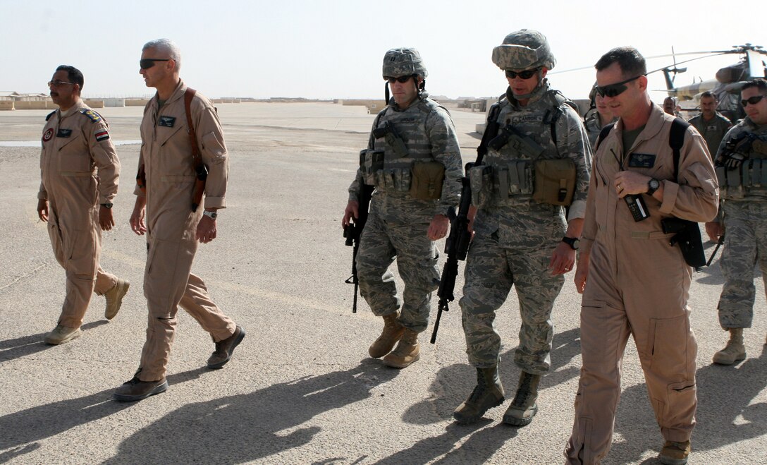 Marines from Combat Logistics Regiment 27 (Forward) greet a detachment of 17 personnel from 4th Squadron, Iraqi Air Force, and their five U.S. Air Force advisors as they arrived aboard Camp Al Taqaddum, Iraq, Nov. 7, 2009.  The Iraqi Ministry of Defense directed that the detachment come to the base in order to provide a rotary wing transportation capability to the Anbar Operations Command.  (U.S. Marine Corps photograph by Lance Cpl. Melissa A. Latty)