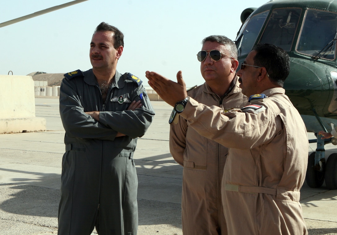Iraqi Air Force personnel, including sLt. Col. Hammadi Muhammad (center), a pilot and safety officer for the detachment from 4th Squadron, Iraqi Air Force, take their first look at their new home and work place aboard Camp Al Taqaddum, Iraq, Nov. 7, 2009.  The Iraqi Ministry of Defense directed that the detachment come to the base in order to provide a rotary wing transportation capability to the Anbar Operations Command.  (U.S. Marine Corps photograph by Lance Cpl. Melissa A. Latty)