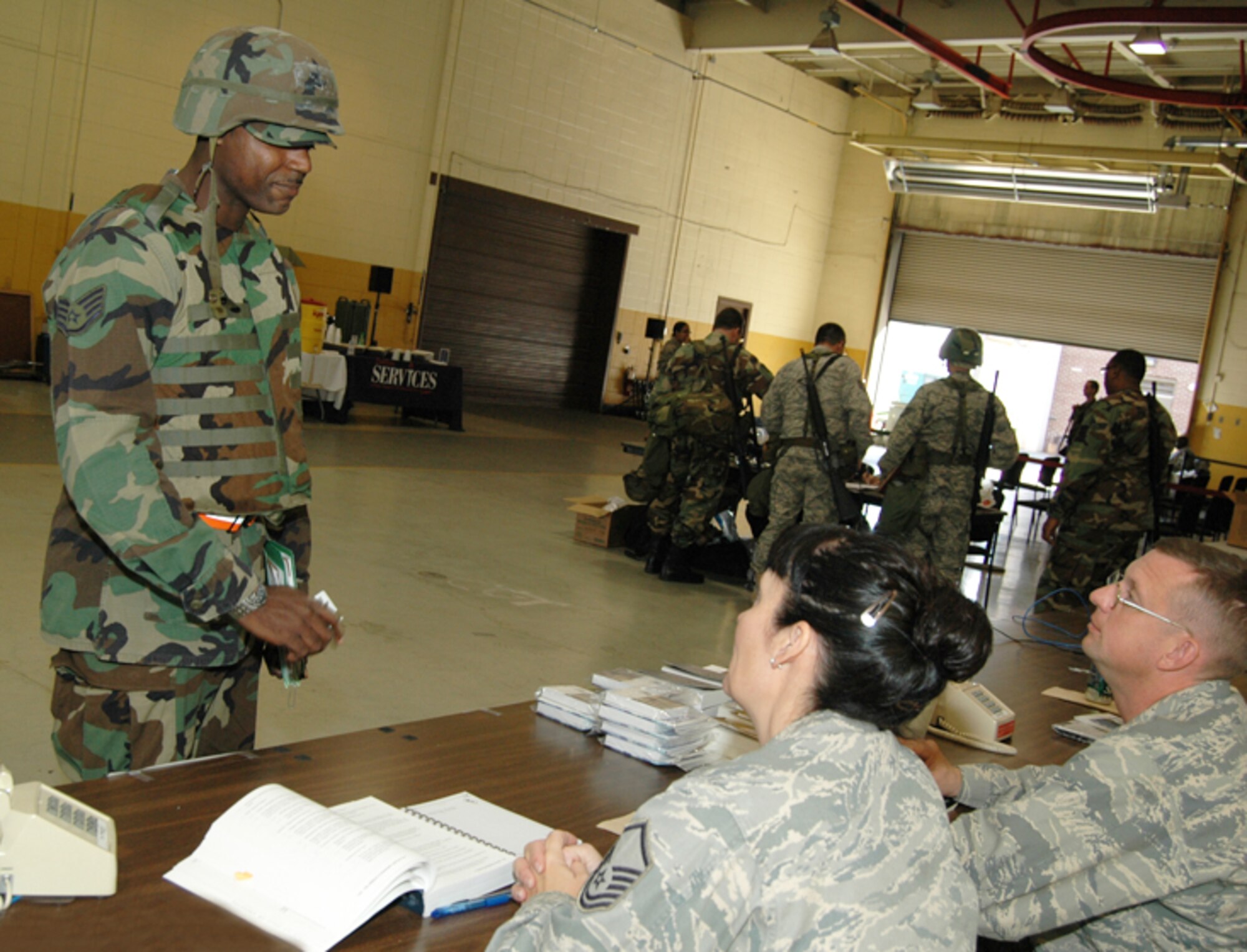 Master Sgt. Donna M. Bridges, paralegal, and Chaplain (Capt.) Douglas A. Collins of the 94th Airlift Wing process a deploying Airman during an Operational Readiness Exercise at Dobbins Air Reserve Base Nov. 7 in preparation for an Operational Readiness Inspection scheduled for Dec. The exercise simulated a short-notice deployment and demonstrated the importance of traditional reservists being fully qualified to deploy anywhere in the world at any given time. (U.S. Air Force photo/Tech. Sgt. James Branch)