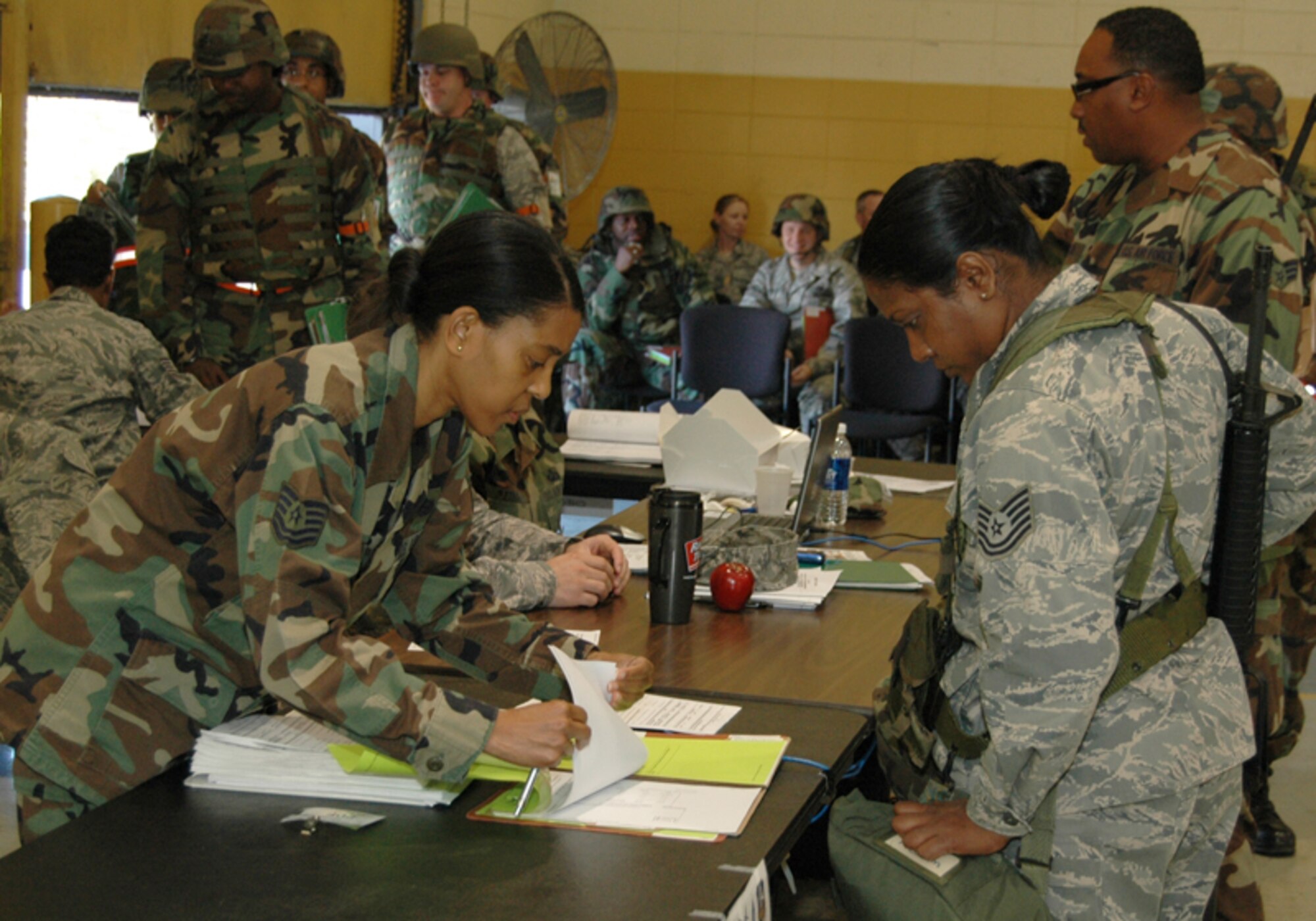 Tech. Sgt. Sonjua A. Williams, family support specialist, 94th Airlift Wing, processes a deploying Airman during an Operational Readiness Exercise at Dobbins Air Reserve Base Nov. 7 in preparation for an Operational Readiness Inspection scheduled for Dec. The exercise simulated a short-notice deployment and demonstrated the importance of traditional reservists being fully qualified to deploy anywhere in the world at any given time. (U.S. Air Force photo/Tech. Sgt. James Branch)