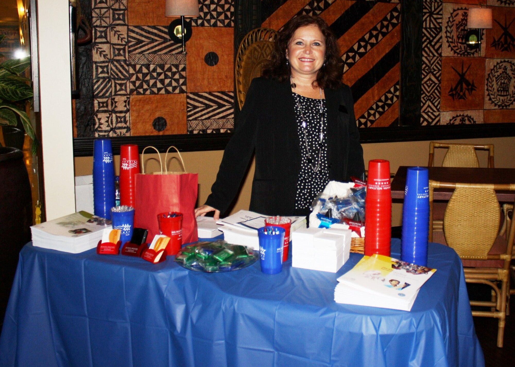 Ms. Rachel Davis, Tricare representative, hands out information to spouses of the 331st Recruiting Squadron who recently attended a brunch in Destin, Fla., which focused on programs of special interest to families. The event addressed a wide range of concerns from educational opportunities for spouses to Tricare health benefits. (U.S. Air Force photo/Michele Brantley)