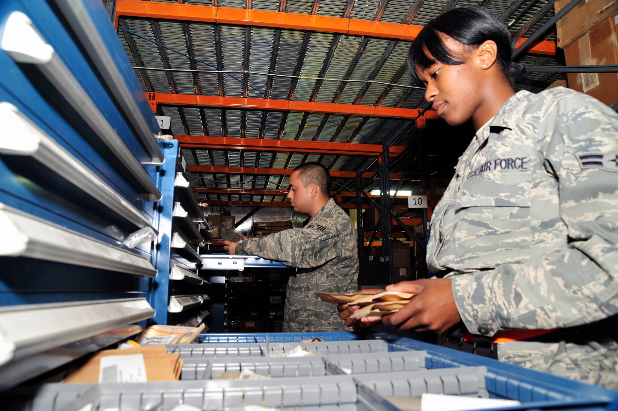 SOUTHWEST ASIA -Senior Airman Jose Barba and Airman 1st Class Erica Franks, 380th Expeditionary Logistic Readiness Squadron flightline supply, check the expiration dates of benchstock items Nov. 7, 2009. Airman Barba is deployed from Tinker Air Force Base, Okla., and hails from Santa Ana, Calif. Airman Franks is deployed from Nellis Air Force Base, Nev., and hails from Port Huron, Mich. (U.S. Air Force photo/Tech. Sgt. Charles Larkin Sr)