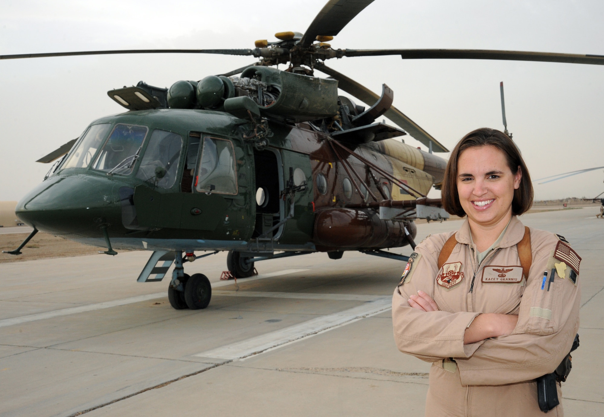 CAMP TAJI, Iraq -- Air Force Capt. Kacey Grannis, 721st Air Expeditionary Advisory Squadron Mi-17 pilot, stands in front of an Mi-17 helicopter after a mission Nov. 5, 2009. Captain Grannis is the first female Mi-17 instructor pilot for Iraqi air force pilots at Camp Taji. She trains, advises and assists Iraqi helicopter pilots to develop their own air force. Captain Grannis is deployed from Andrews Air Force Base, Md., and hails from Sturgis, S.D.  (U.S. Air Force photo/Tech. Sgt. Johnny L. Saldivar)
