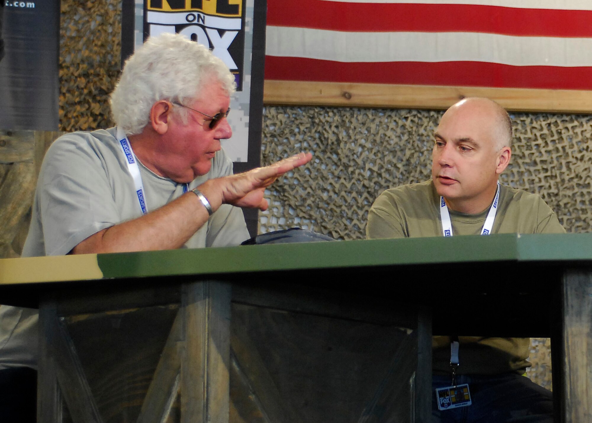 BAGRAM AIR FIELD, Afghanistan -- David Hill (left), chairman of Fox Sports, and Chuck Noble (right), lighting designer, discuss the progress of the set Nov. 6, 2009.  The Fox Sports members transformed the MWR clamshell into a set for the "Fox NFL Sunday" team.  The "Fox NFL Sunday" team is scheduled to broadcast live Nov. 8, 2009 from here.  Mr. Hill hails from Los Angeles, and Mr. Noble hails from White Plains, N.Y.  (U.S. Air Force photo/Senior Airman Felicia Juenke)