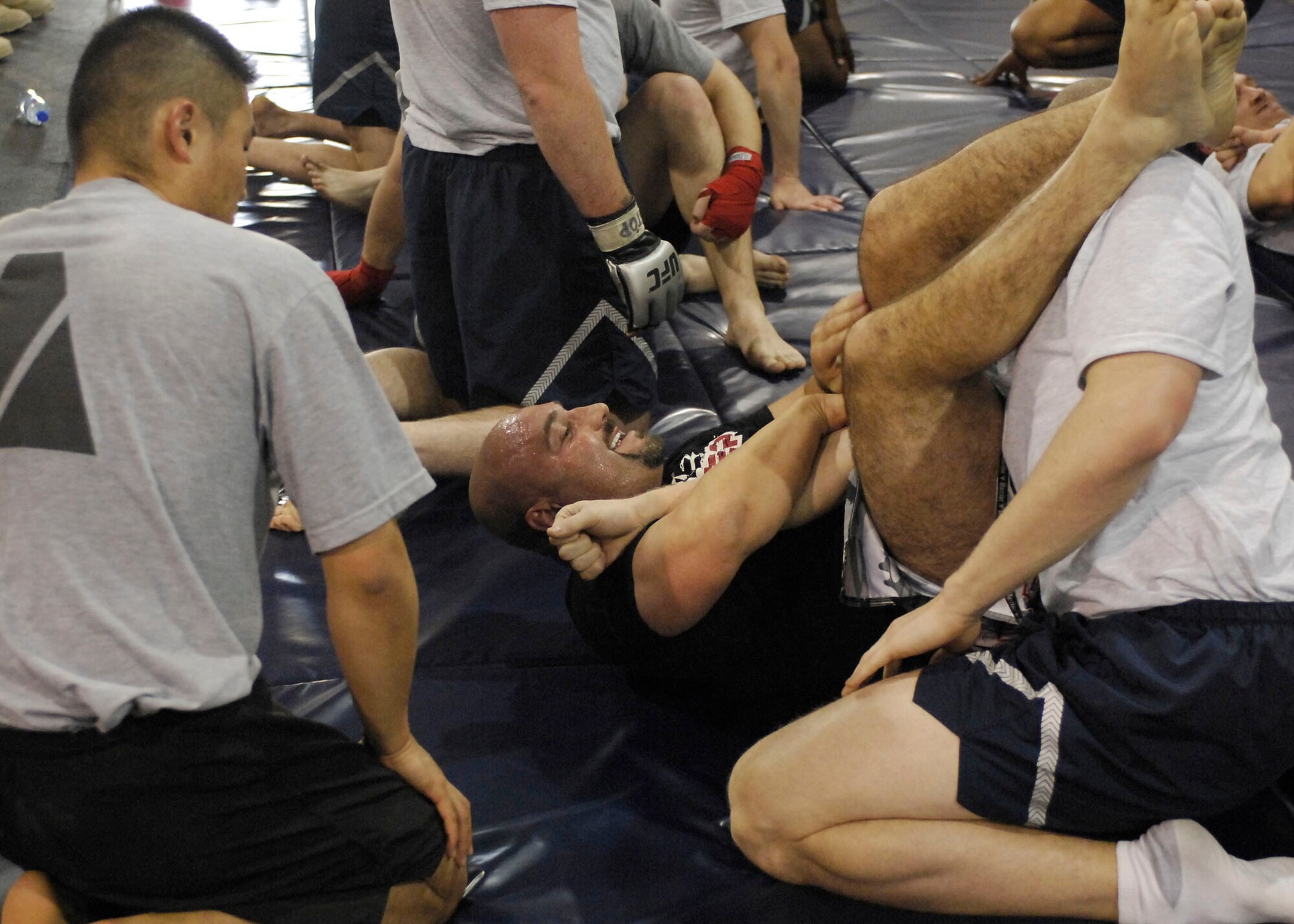BAGRAM AIR FIELD, Afghanistan -- Jay Glazer, senior NFL writer for Fox Sports, shows members of a mixed martial arts class how to properly perform an arm bar Nov. 6, 2009.  Mr. Glazer along with Howie Long, Terry Bradshaw, Michael Strahan, Jimmy Johnson, and Curt Menefee are visiting troops deployed to Bagram to thank them for their role in Operation Enduring Freedom.  The "Fox NFL Sunday" team is scheduled to broadcast live Nov. 8 from here.  (U.S. Air Force photo/Senior Airman Felicia Juenke)