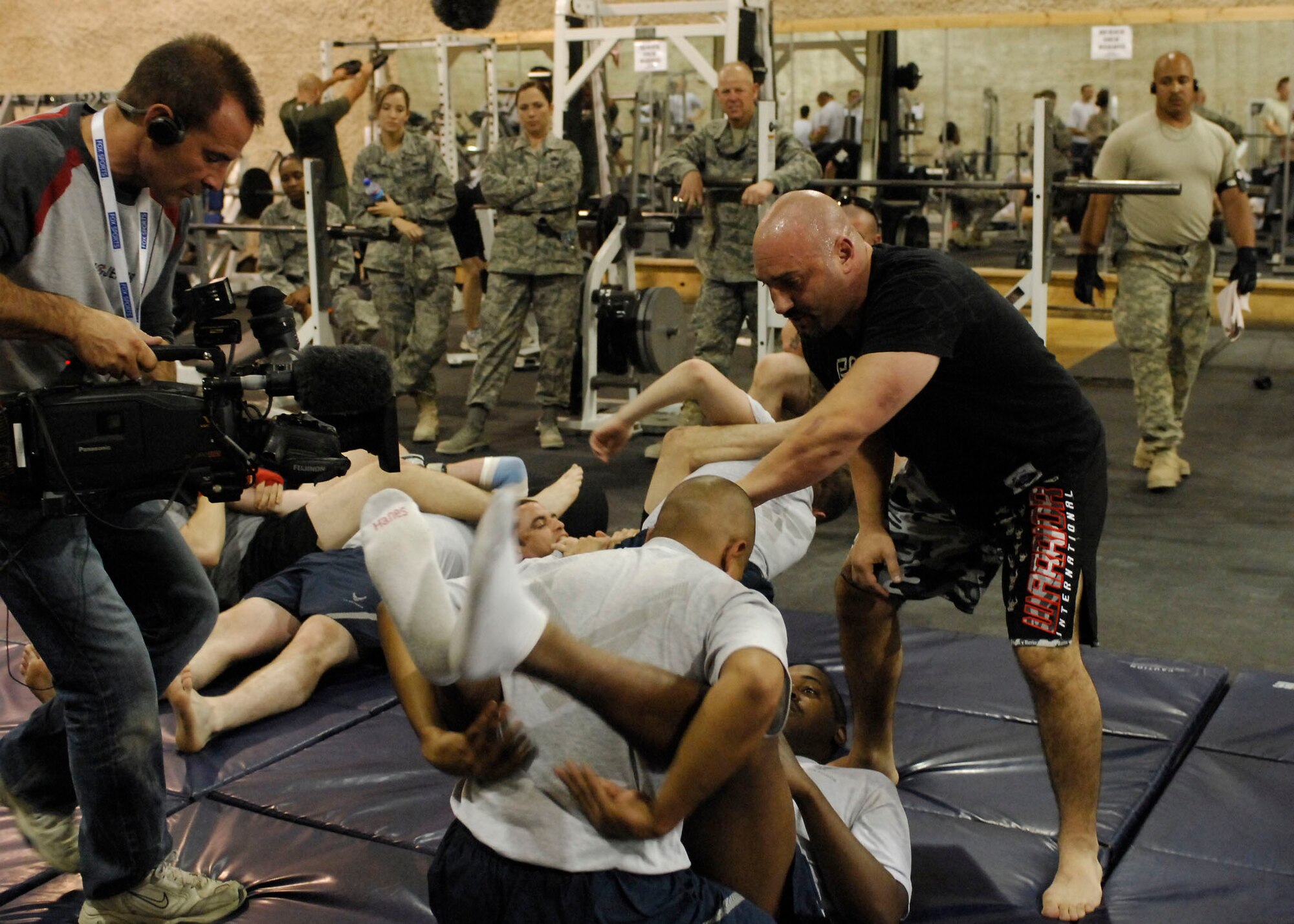 BAGRAM AIR FIELD, Afghanistan -- Jay Glazer, senior NFL writer for Fox Sports, tells an Airman where to move his leg during a mixed martial arts class Nov. 6, 2009.  Mr. Glazer along with Howie Long, Terry Bradshaw, Michael Strahan, Jimmy Johnson, and Curt Menefee are visiting troops deployed to Bagram to thank them for their role in Operation Enduring Freedom.  The "Fox NFL Sunday" team is scheduled to broadcast live Nov. 8 from here.  (U.S. Air Force photo/Senior Airman Felicia Juenke)