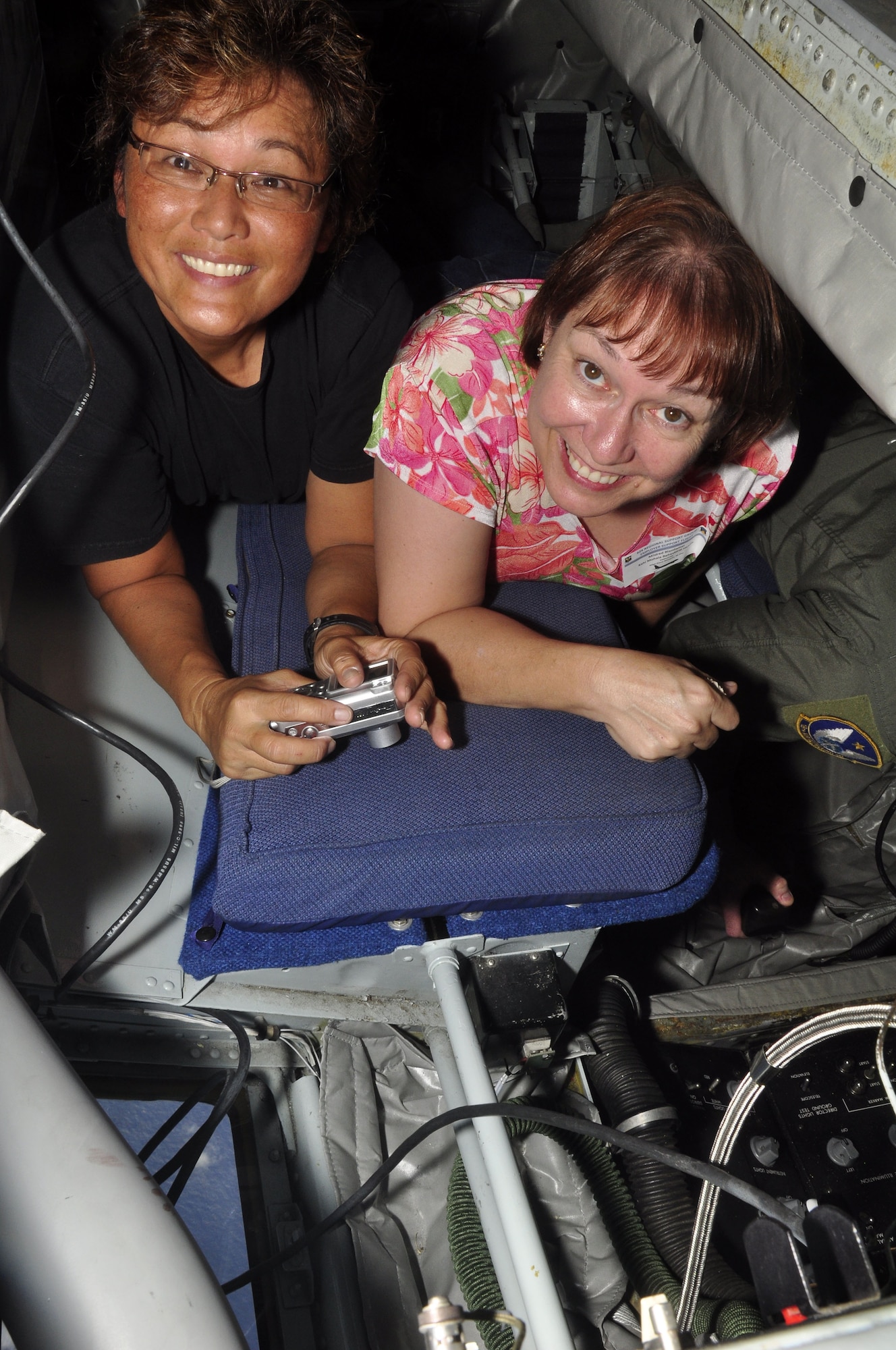 Master Sgt. Diane Marques, 48th Aerial Port Squadron, and her civilian employer Mildred Blandamer, Kahi Mohala Behavioral Health, squeeze in to watch the boom operator of a KC-135 Stratotanker refuel a Hawaii Air National Guard F-15 Eagle over the Hawaiian Islands Nov. 7. They were a part of the 624th Regional Support Group’s first-ever Employer Support Flight at Hickam Air Force Base, Hawaii. The event, held in co-operation with the Hawaii Committee of the Employer Support for the Guard and Reserve, helped employers better understand the time and sacrifice their employees invest in their role as Air Force Reservists.The KC-135 used for Saturday's Employer Support Flight is assigned to the 452nd Air Mobility Wing at March Air Reserve Base, Calif. (Air Force photo/Master Sgt. Daniel Nathaniel)