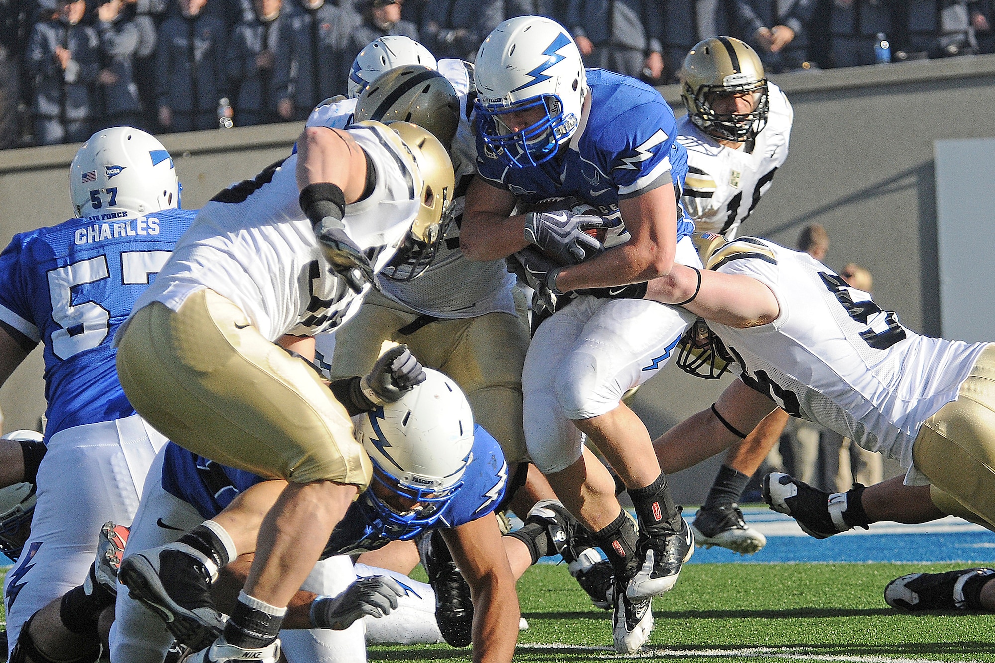 Falcons running back Jared Tew clashes with Black Knights defenders during the Army-Air Force game at Falcon Stadium Nov. 7, 2009. Tew, a junior and native of Park City, Utah, had his second 100-yard game of the season with 102 yards on 25 carries in Air Force's 35-7 victory. (U.S. Air Force photo/Rachel Boettcher)