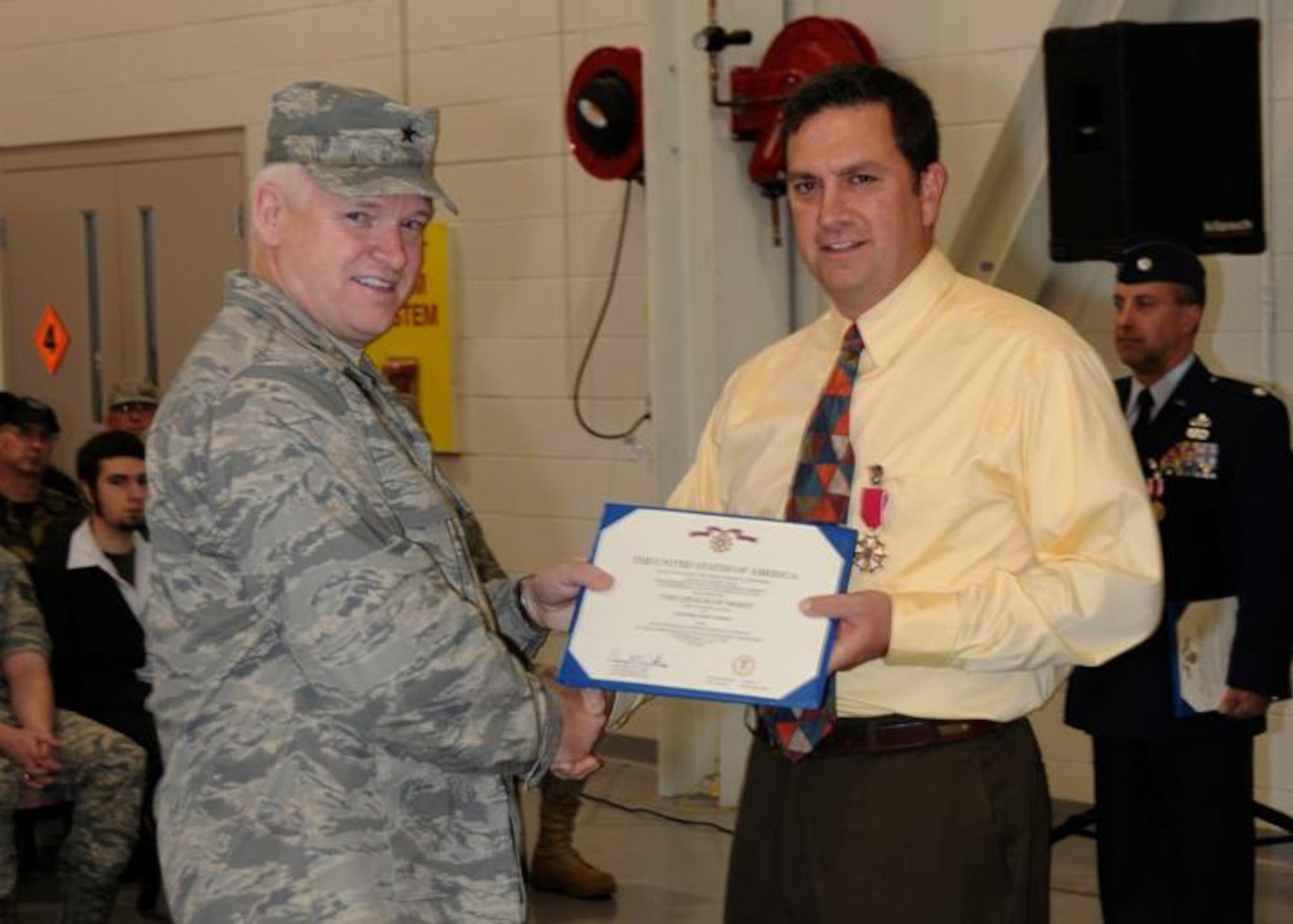 Col. Gary Keefe is presented the Legion of Merit from Brig. Gen. L. Scott Rice on the occasion of his retirement 