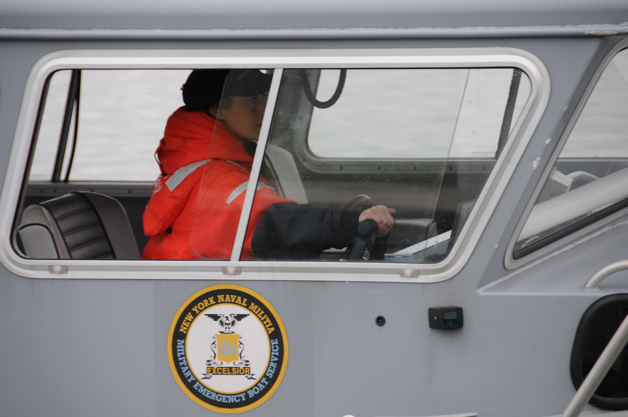 BM2 Dawn Burgess, New York Naval Militia, takes the helm, controlling every move of the vessel. Burgess along with other NYNM members participated in a recent Vigilant Guard exercise, that enabled emergency civilian and military resopnders to work side by side with one common goal, training. (USAF Photo/Staff Sgt. Peter Dean)