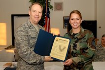 Col Kevin W. Bradley, 174th Fighter Wing Commander presents Staff Sgt. Samantha Dougherty with a Certificate of Promotion to the Rank of Staff Sgt. Dougherty was among 37 unit members recognized at a special Promotion Ceremony on November the 8th, 2009. (RELEASED)