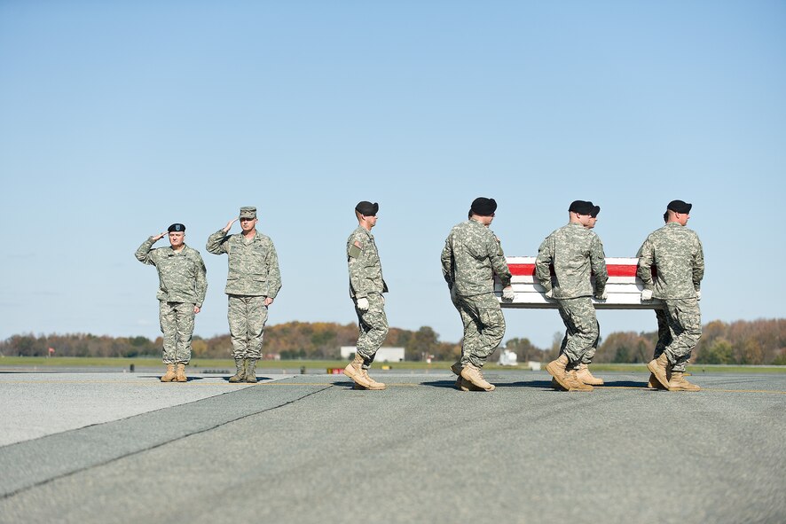 A U.S. Army carry team transfers the remains of Army Spc. Julian L. Berisford, of Benwood, W.V., at Dover Air Force Base, Del., November 6. Spc. Berisford was assigned to 3rd Battalion, 509th Parachute Infantry Regiment, 4th Brigade Combat Team (Airborne), 25th Infantry Division, Fort Richardson, Alaska. (U.S. Air Force photo/Roland Balik)