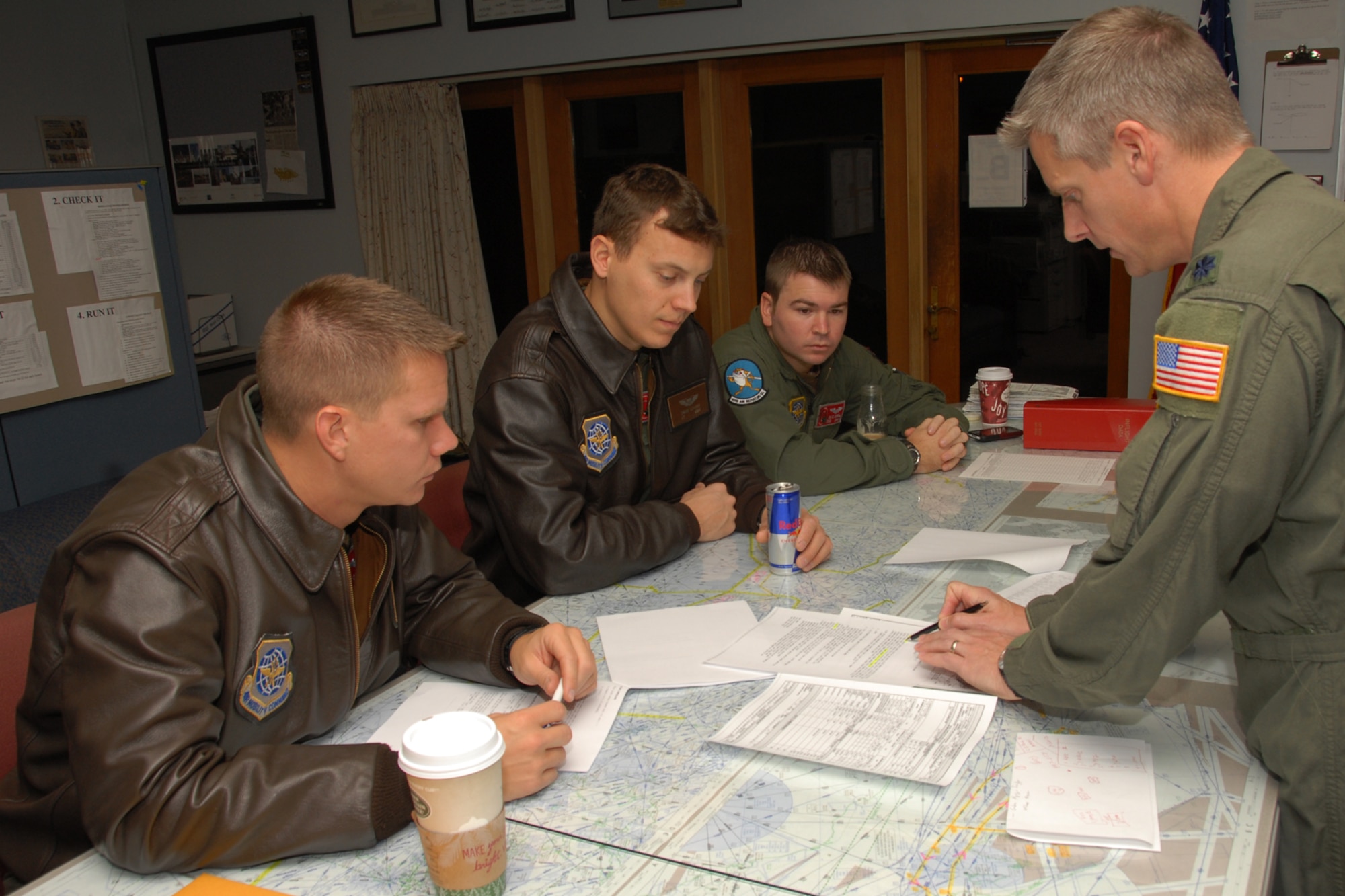 Lieutenant Colonel Randy Dyer, (right), Northeast Tanker Task Force Commander briefs the crew of Gold 23:   Captain Michael A. Dirnberger, aircraft commander; First Lieutenant David A. Lohrer, first pilot; and Technical Sergeant David A. Sorrell II, in-flight refueling specialist during a mission brief at Pease Air National Guard Base, New Hampshire on November 7th, 2009.   They are participating in Coronet East mission where six F-22 Raptors from the 1st Fighter Wing, Langley Air Force Base, Virginia are deployed to Moron Air Base, Spain.  The event marks the first deployment eastbound of the F-22 Raptors to the Central Command Area of Responsibility at Al Dafra Air Base, United Arab Emirates.  (U.S. Air Force photo/Staff Sgt. Curtis J. Lenz)
