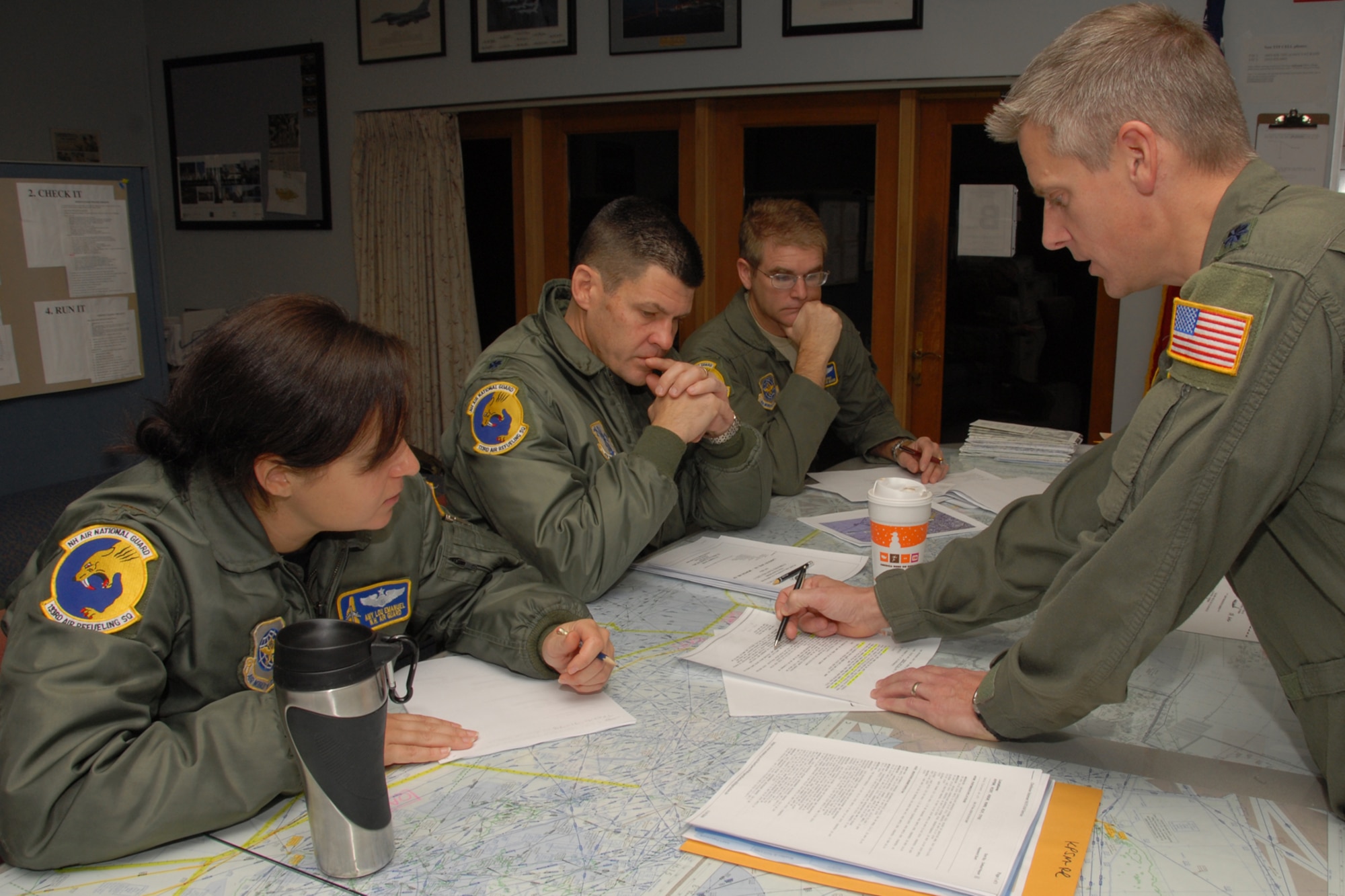 Lieutenet Colonel Randy Dyer, (right), Northeast Tanker Task Force Commander briefs his crew: Major Amy L. Emanuel, first pilot; Lt. Col. Scott. L. Hoyt, aircraft commander; and Technical Sergeant Mark W. Brophy, in-flight refueling specialist during a mission brief at Pease Air National Guard Base, New Hampshire on November 7th, 2009.  They are participating in Coronet East mission which deploys six F-22 Raptors from the 1st Fighter Wing, Langley Air Force Base, Virginia to Moron Air Base, Spain.  The event marks the first deployment eastbound of the F-22 Raptors to the Central Command Area of Reponsibility at Al Dafra Air Base, United Arab Emirates.  (U.S. Air Force photo/Staff Sgt. Curtis J. Lenz)